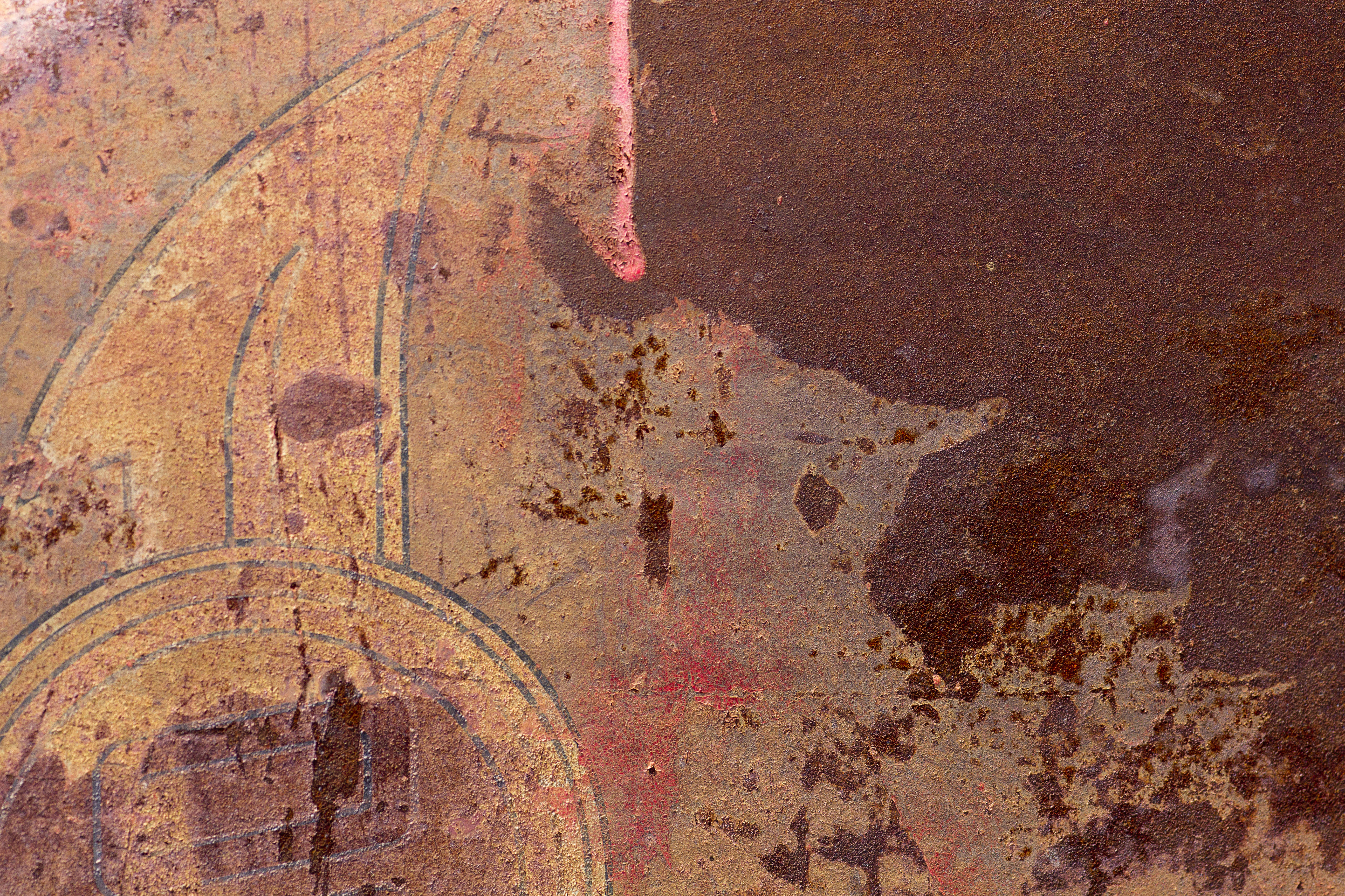 Silver skin has pits, grey circles mark the metal, grit holds the surface