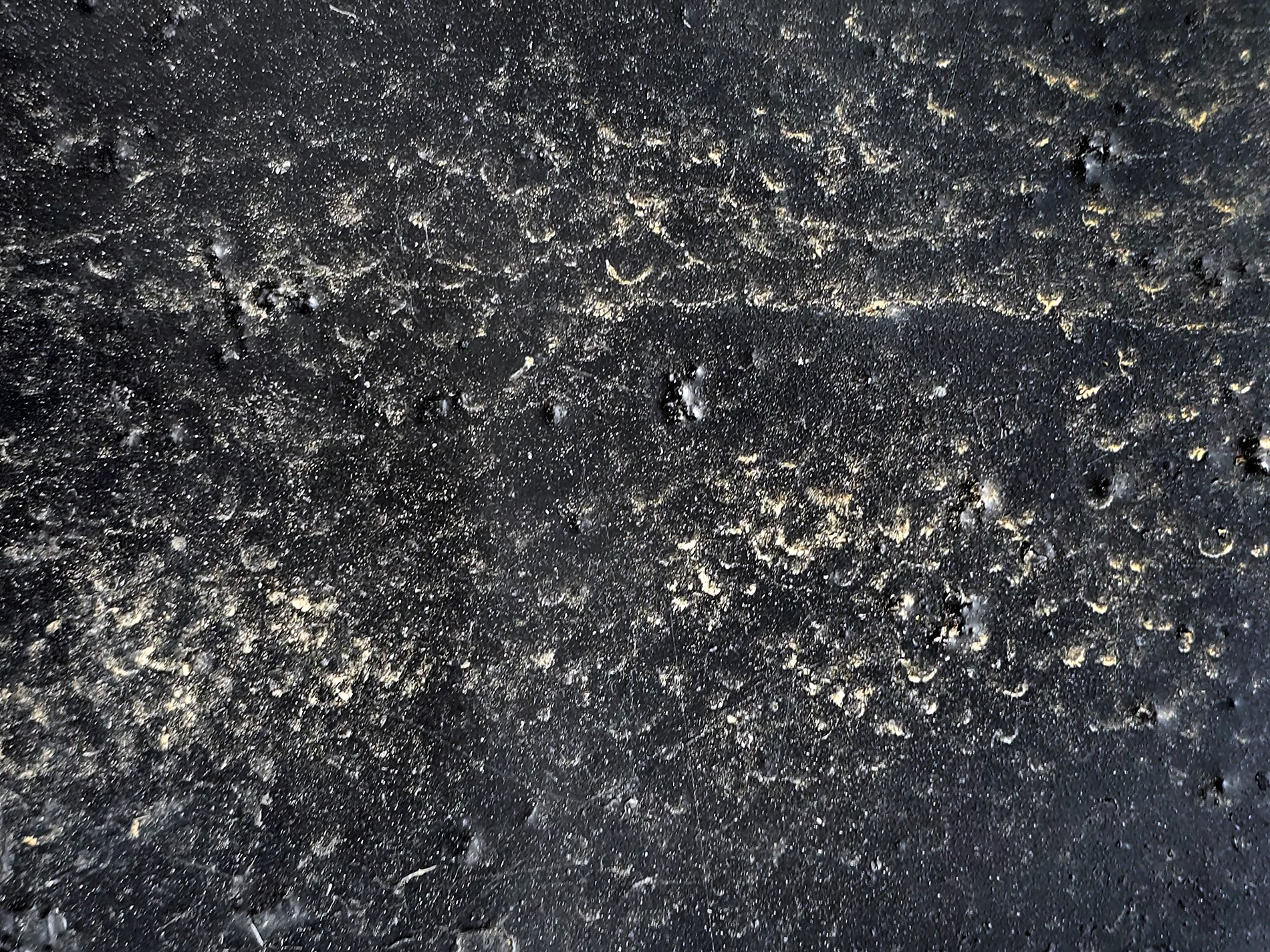 Black pits in the gloss, golden grit fills every scar, time claims the finish