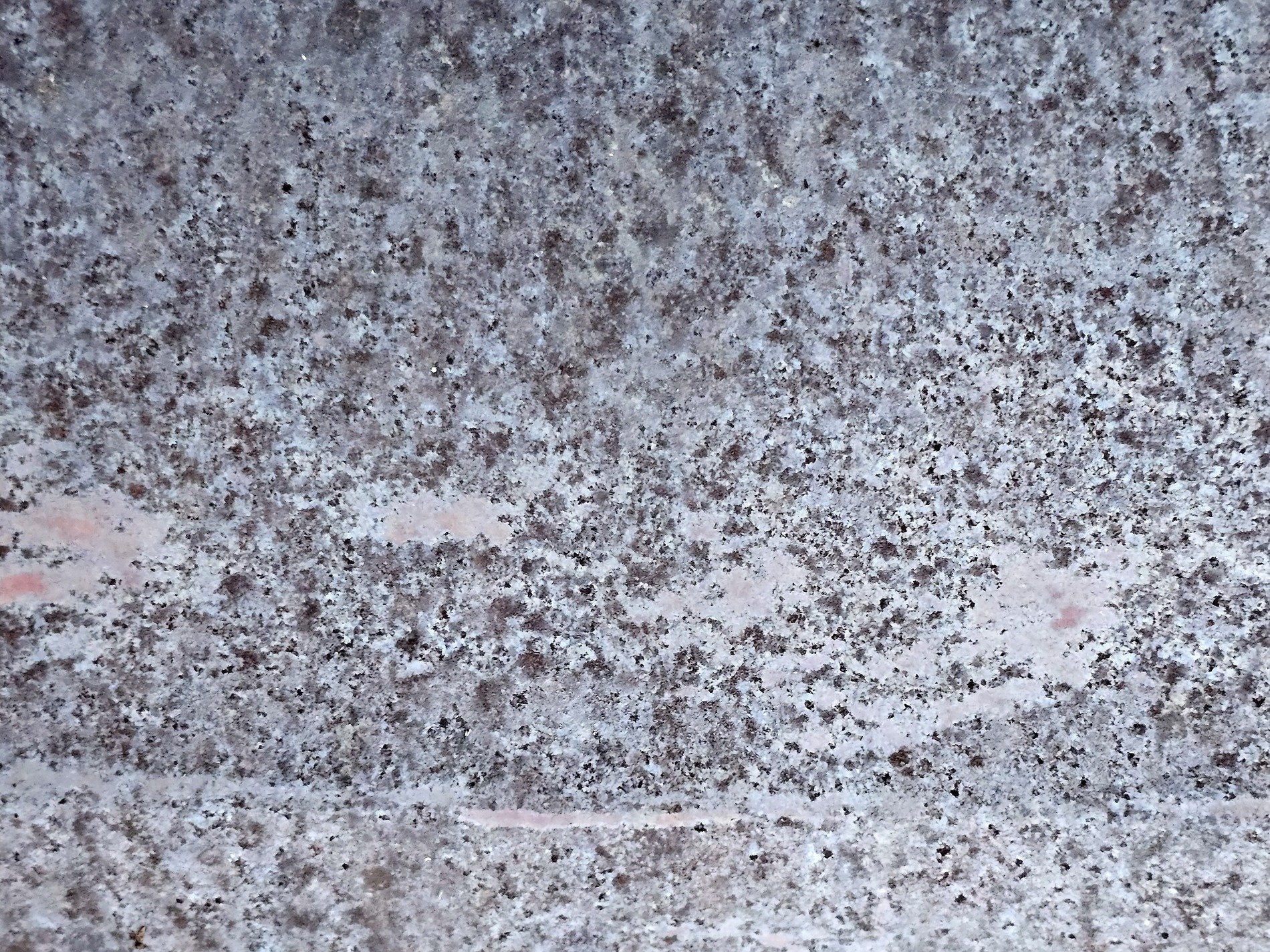 Granite grains collide, cooling magma held in time, speckled grey remains