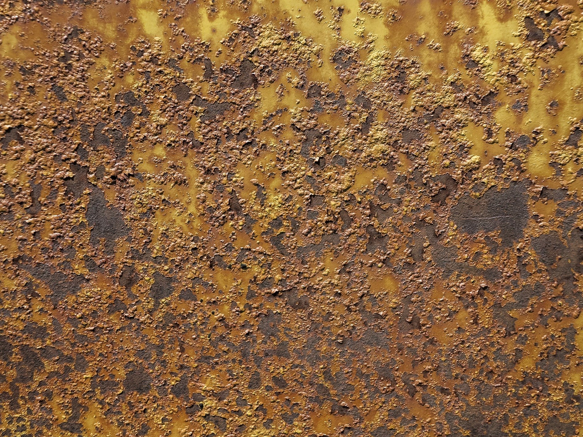 Yellow paint flakes off, deep rust consumes the iron, decay blooms in gold