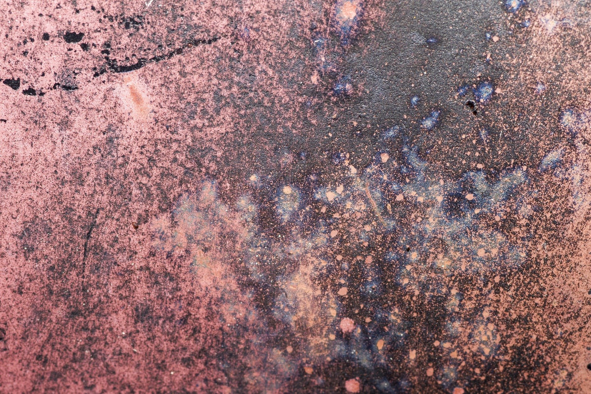 Rose dust meets the dark, oxidation blooms in blue, metal wears its age