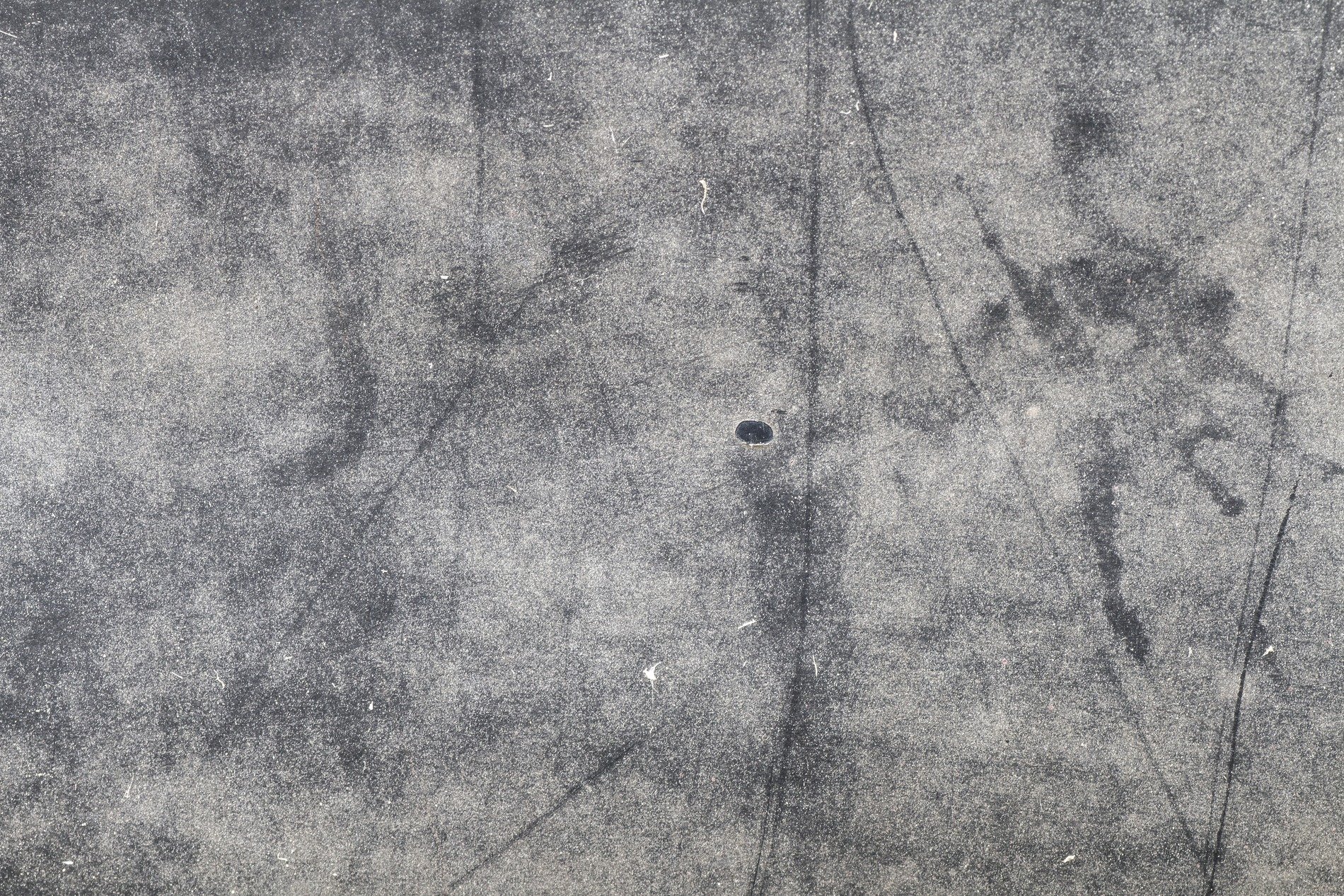 Blue fields meet the rust, orange veins bleed on the steel, grit holds the shoreline