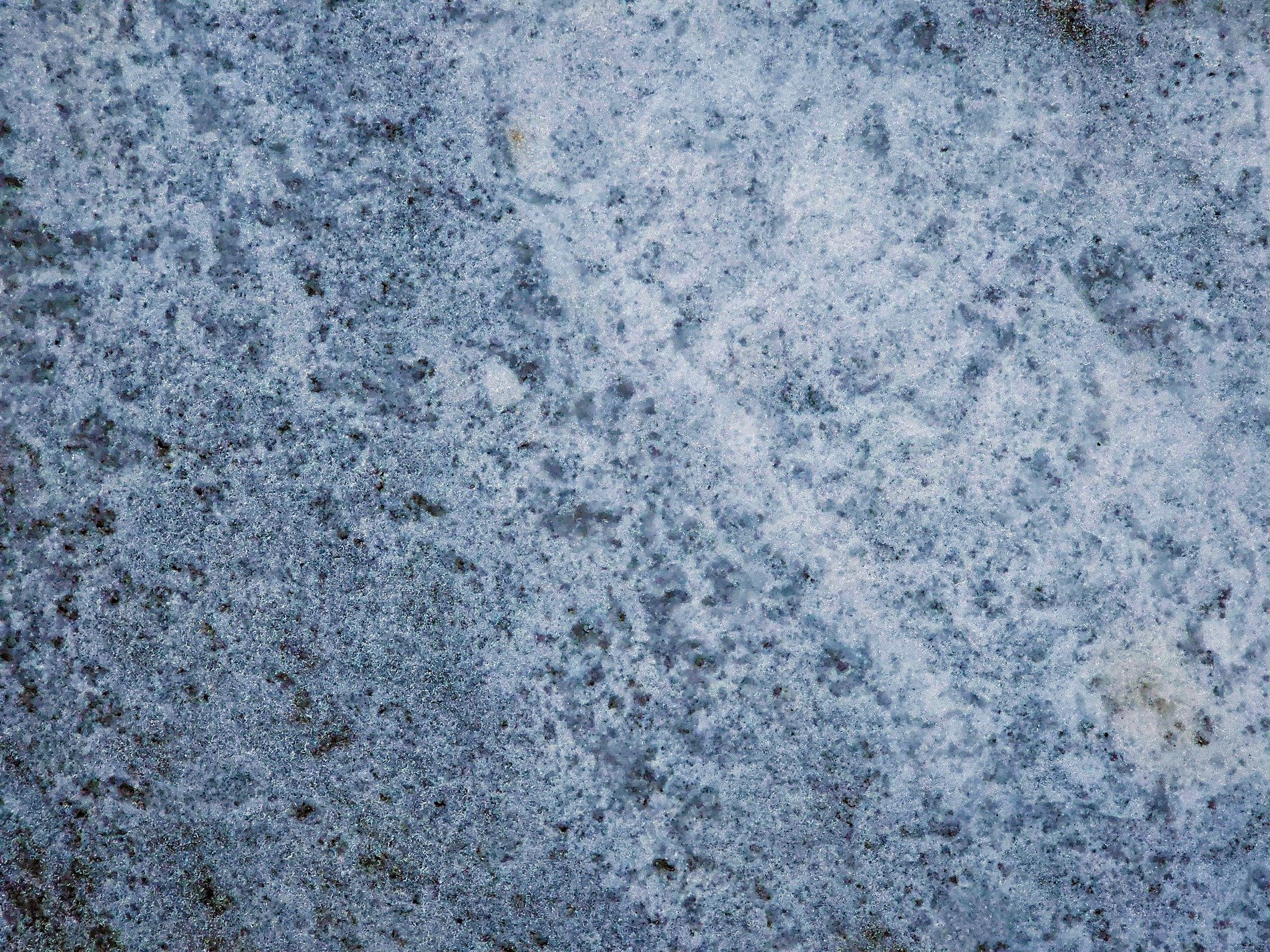 Blue fields turn to grey, mottled skin on the cold stone, ice traces the grit