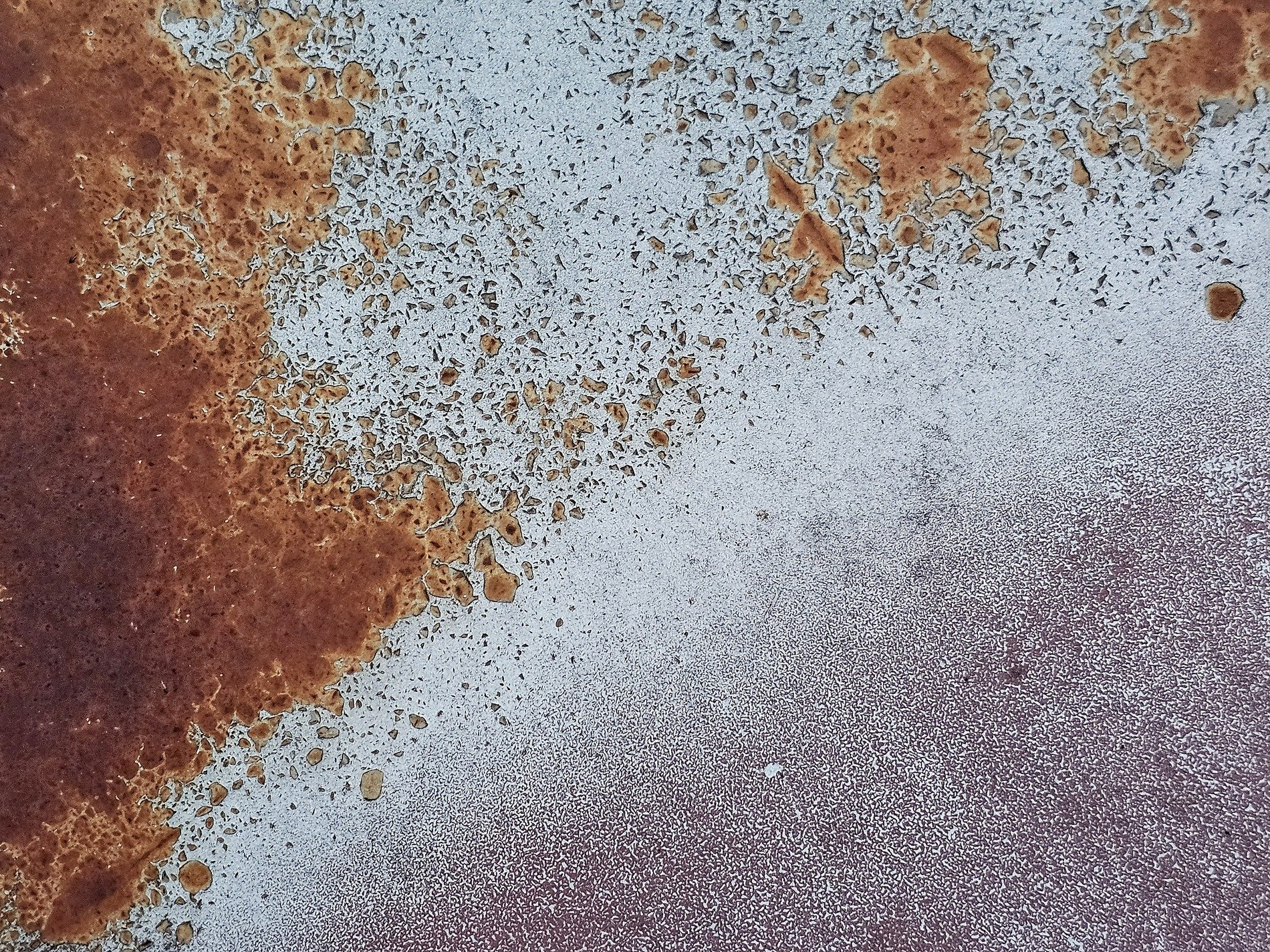 Blue paint flakes away, orange rust claims the cold steel, time wears down the coat