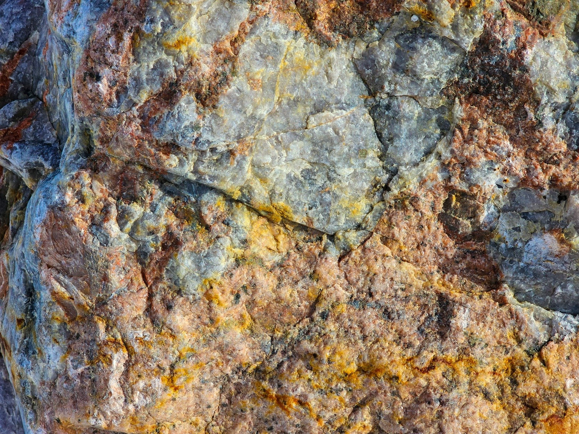 Blue shards meet the frost, orange veins bleed through the field, grit marks the fracture