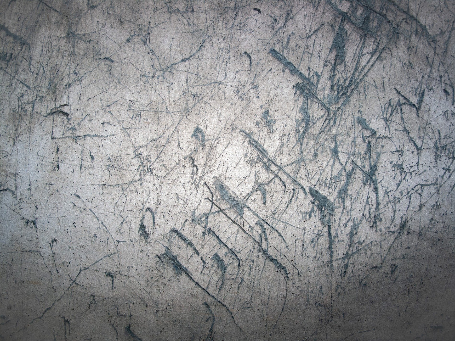 Blue skin has light marks, jagged lines trace the field, grit marks the finish