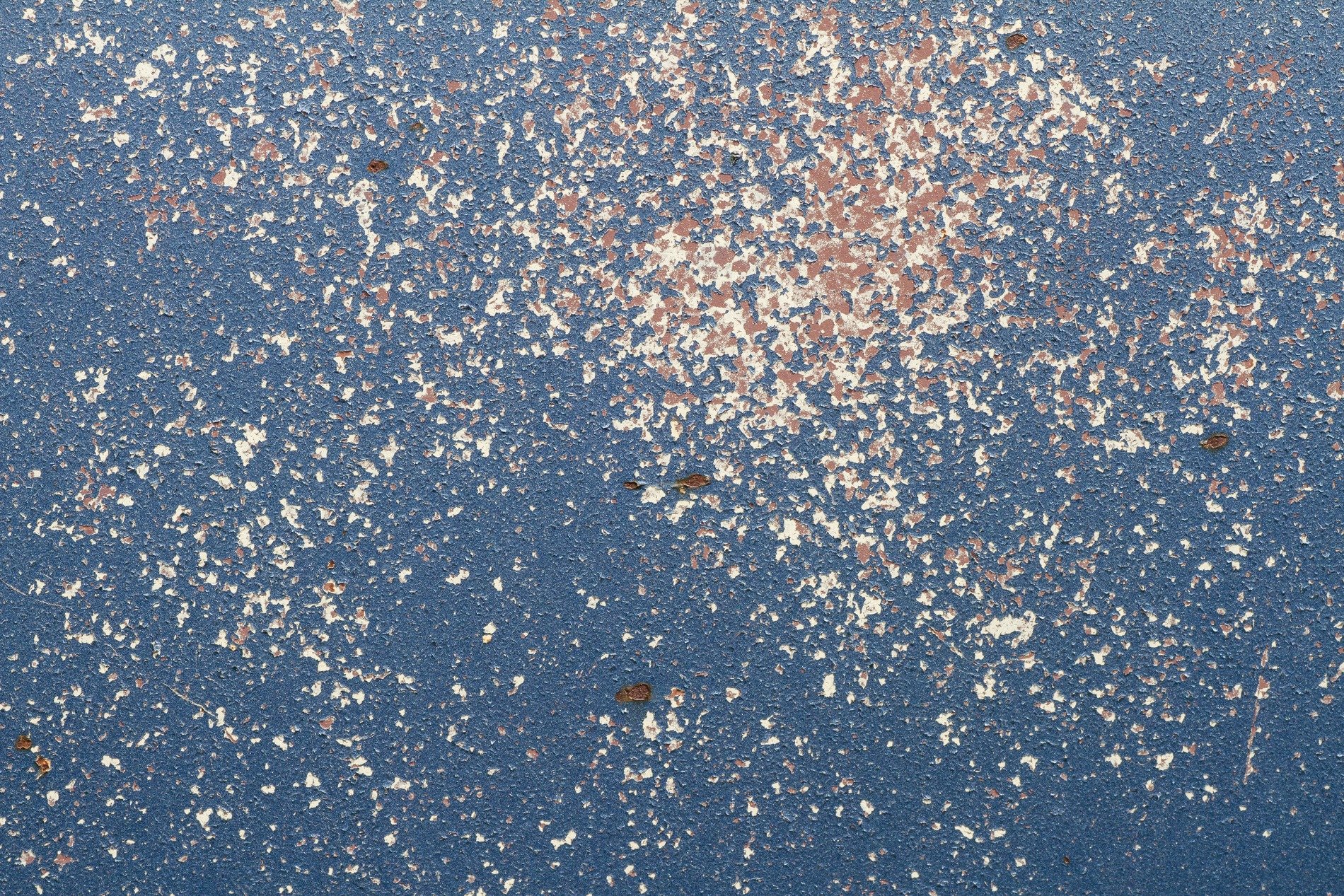 Blue paint flakes away, ivory dust coats the frame, iron turns to rust