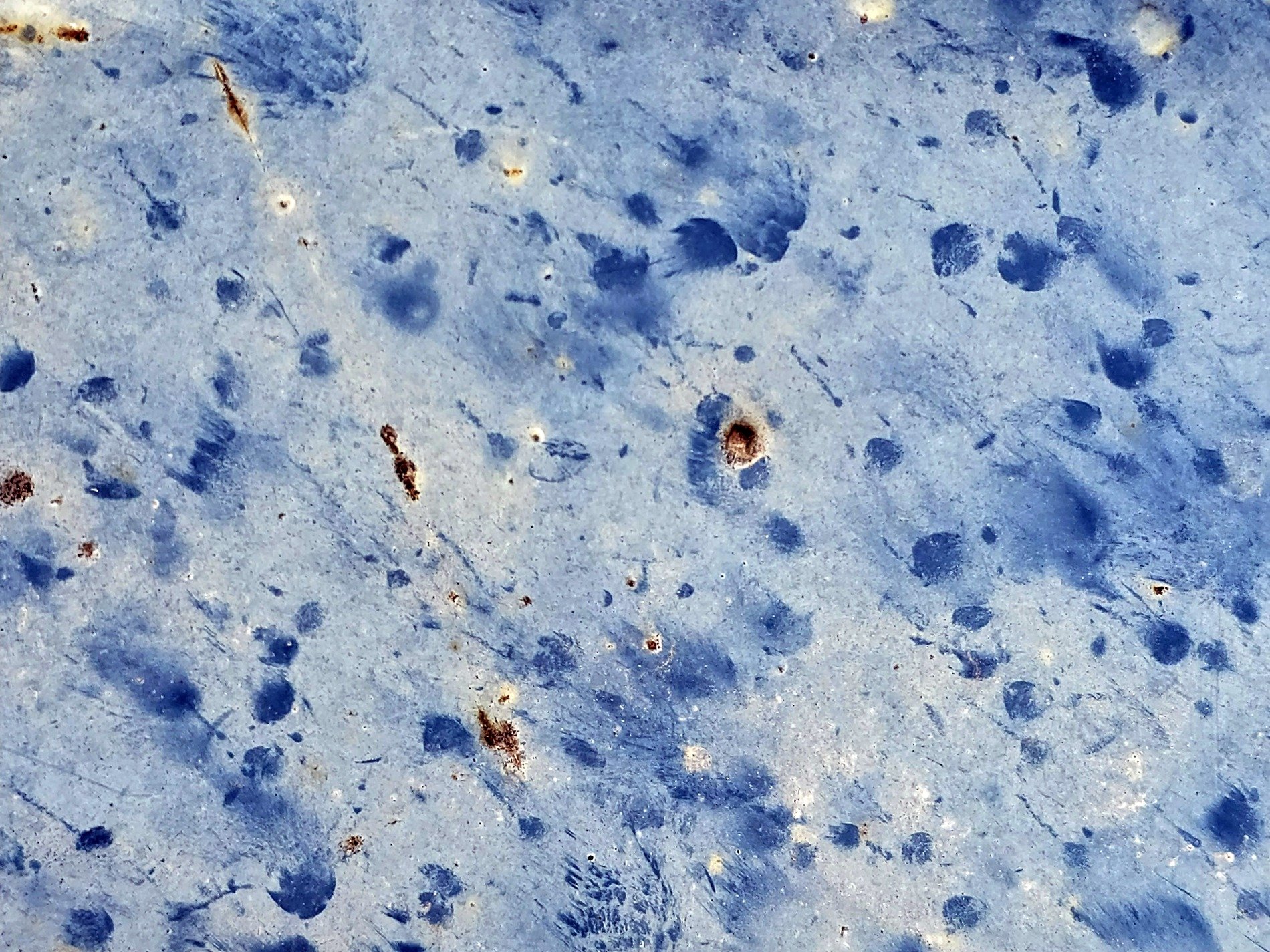 Blue spots on the wall, dark smudges on the pale skin, rust breaks the surface