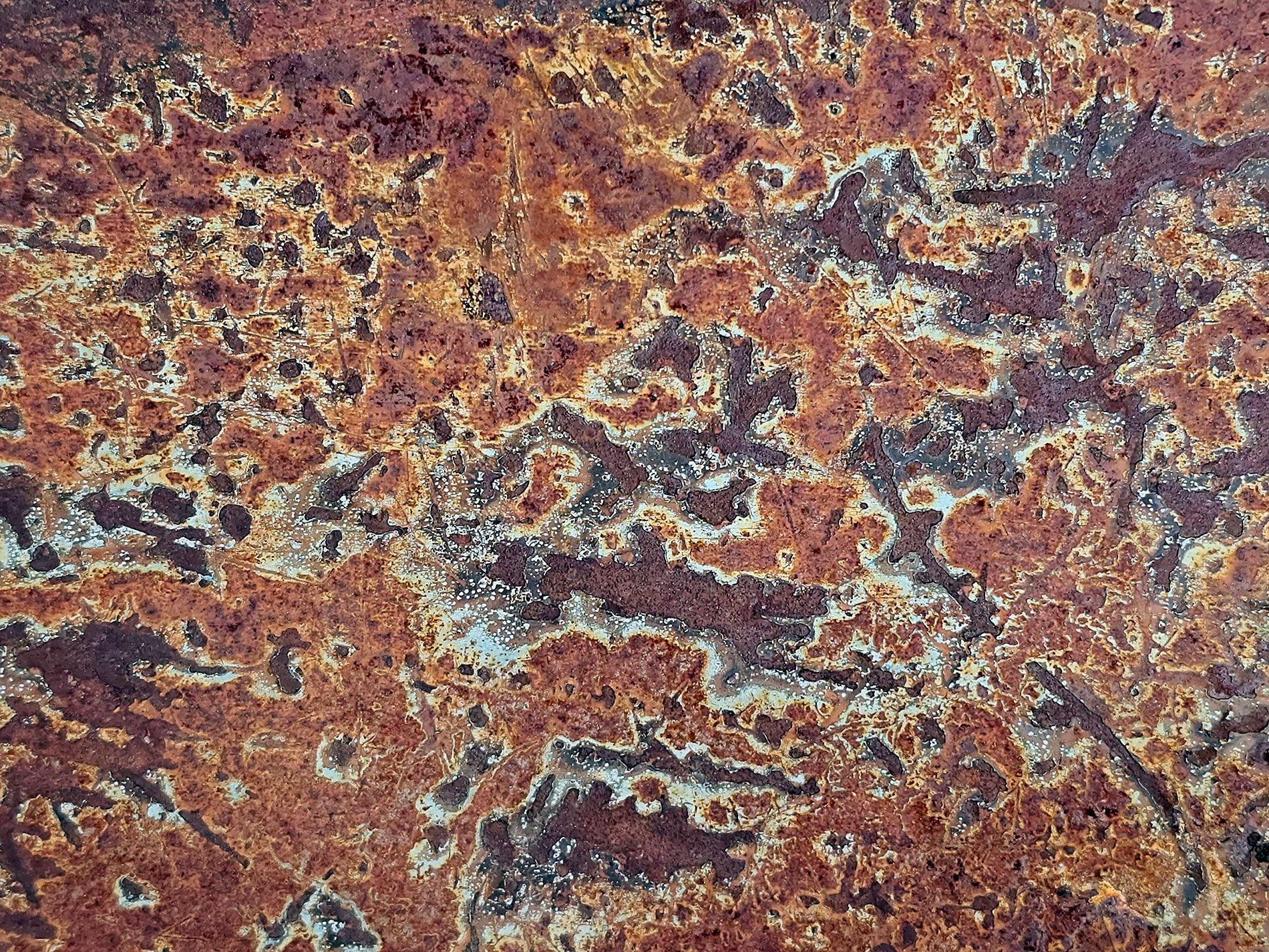 Brown islands of rust, corroded maps on the steel, iron turns to dust.