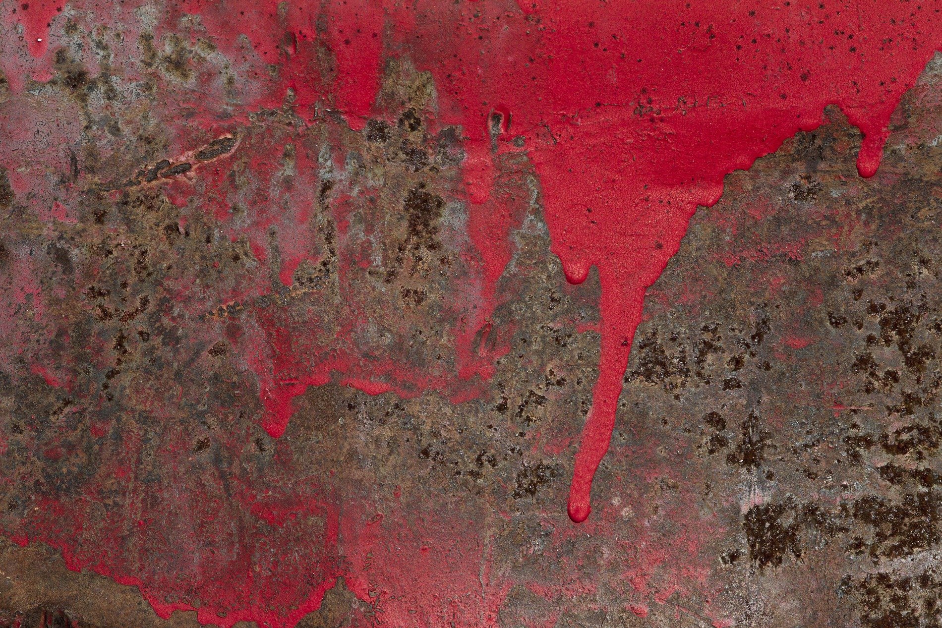 Red paint drips like blood, rust consumes the metal plate, time wears down the steel