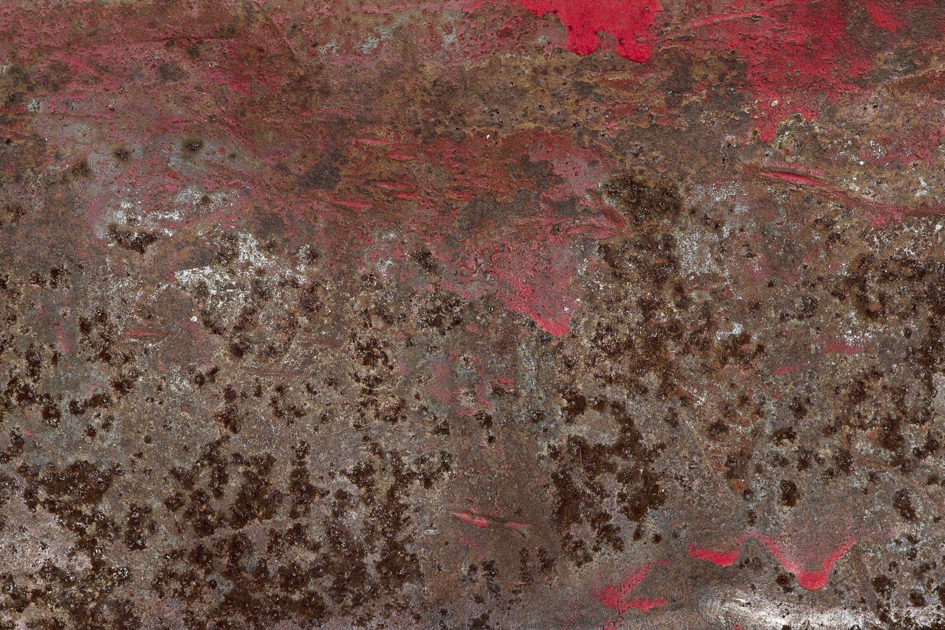 Red paint flakes away, oxidation claims the steel, iron turns to dust