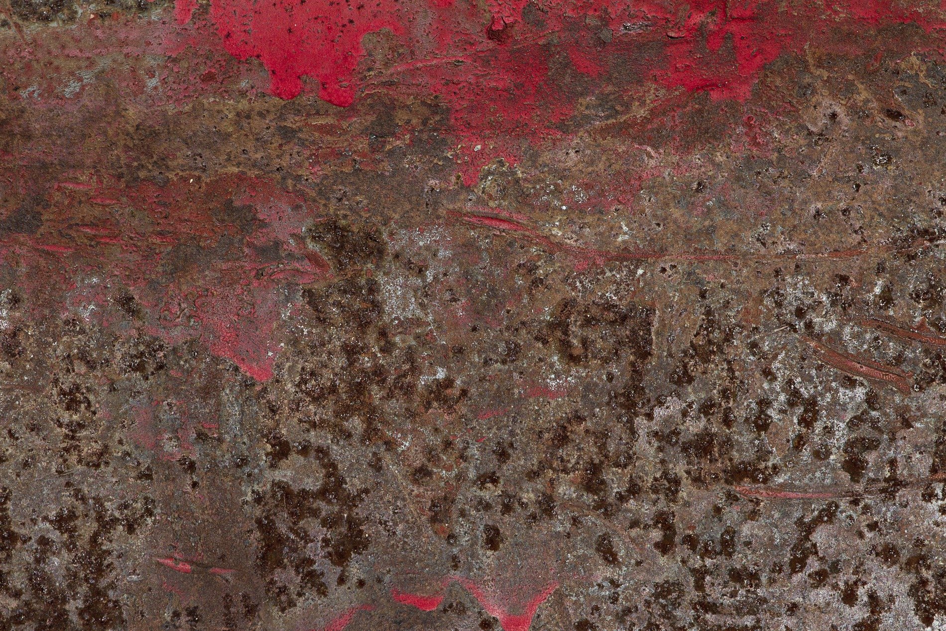 Crimson paint recedes, brown rust consumes the iron, time leaves heavy scars