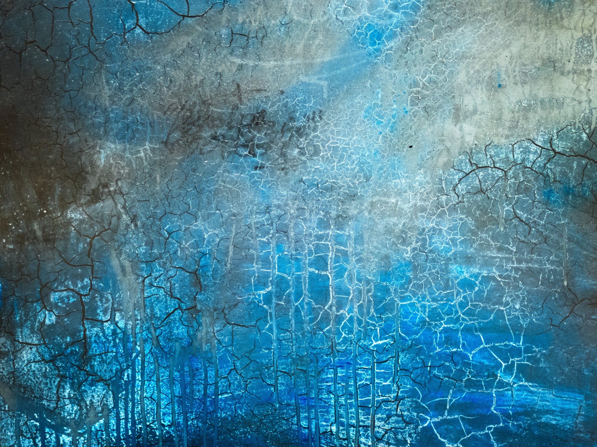 Clear streaks hold the light, jagged marks trace the surface, grit meets the shadow