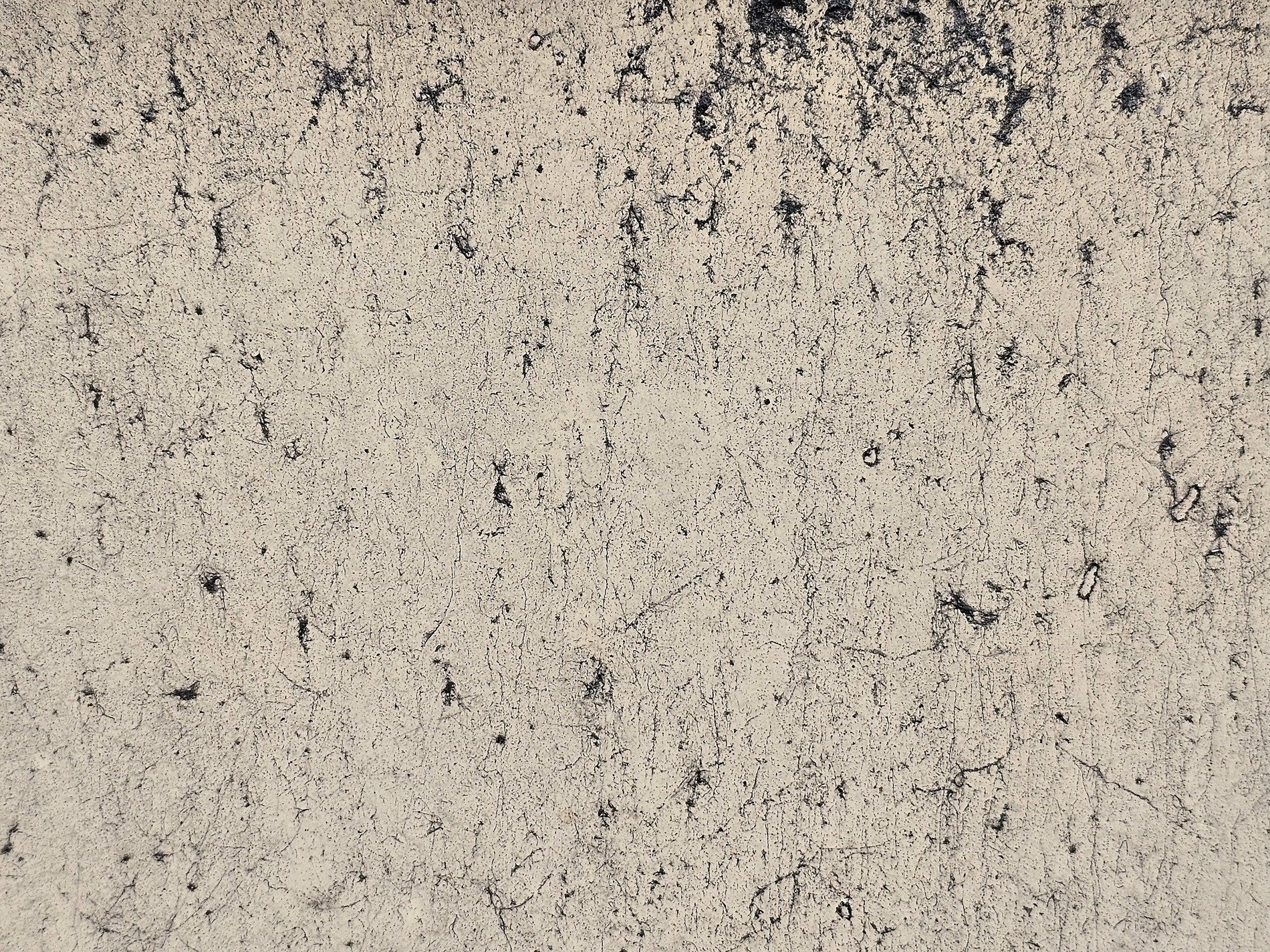 Pale paint starts to fade, dark cracks trace a silent web, time wears down the skin