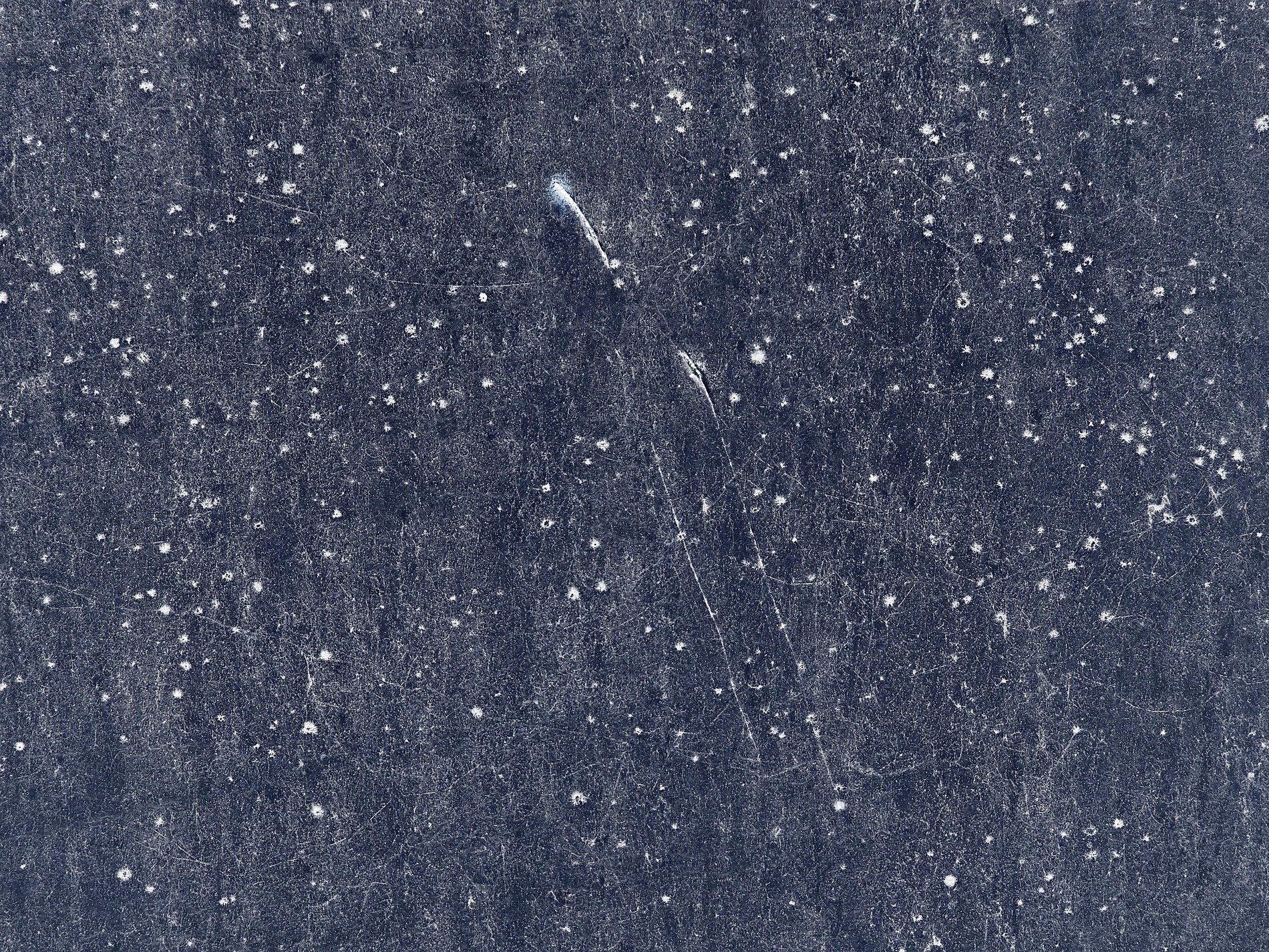 Dark sky of the ground, white stars etched in cold metal, scars mar the deep blue