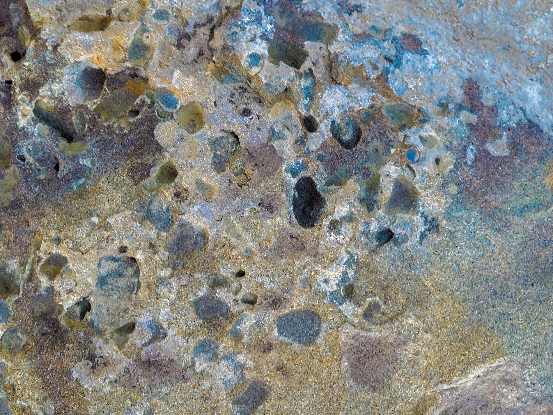 Dark grains flow through deep, rough marks trace the surface, grit holds the shadow