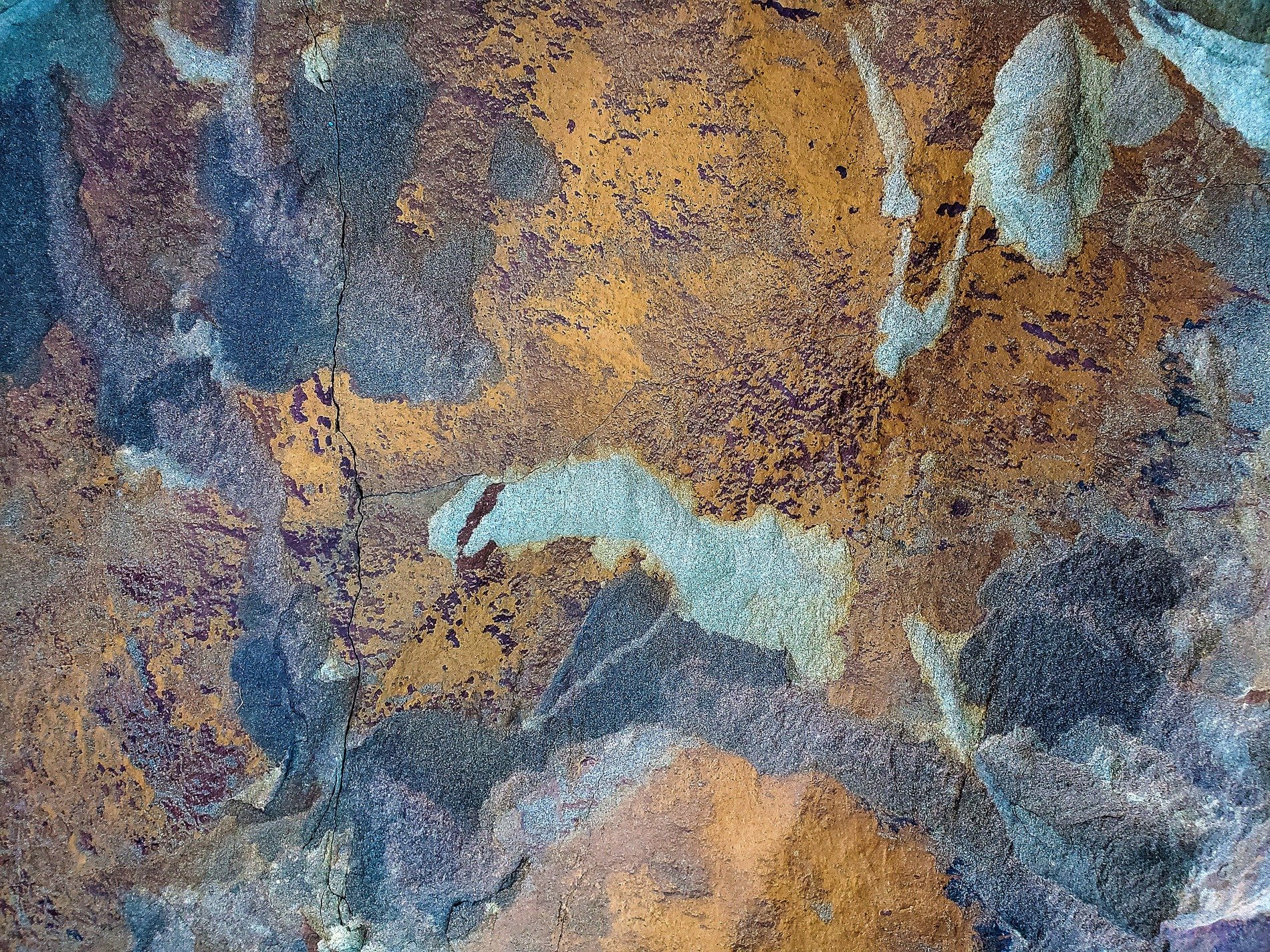 Dark pits mark the depth, jagged scars mark up the skin, grit marks the finish