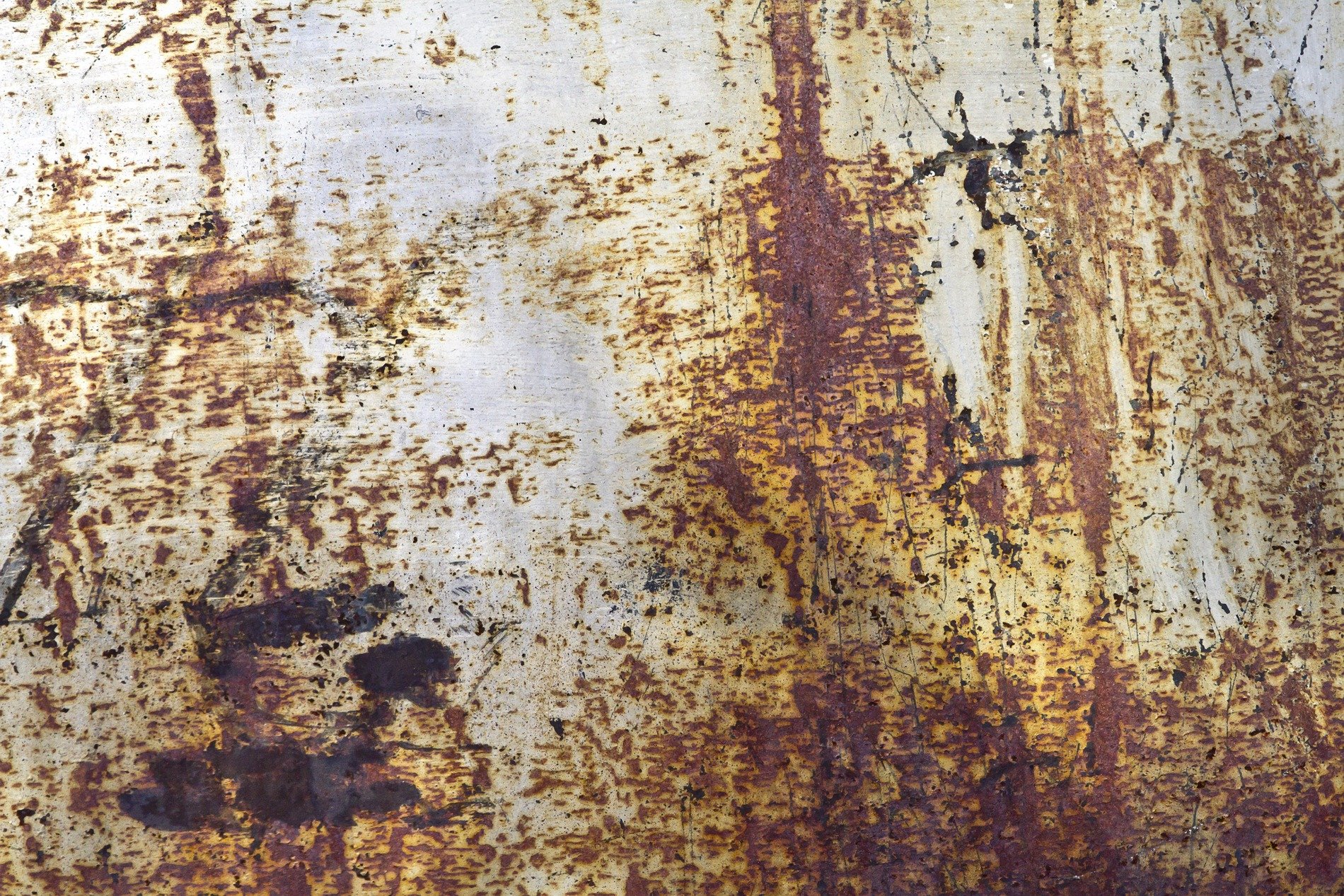 Dark wood shows the grain, vertical lines trace the board, grit holds the pattern