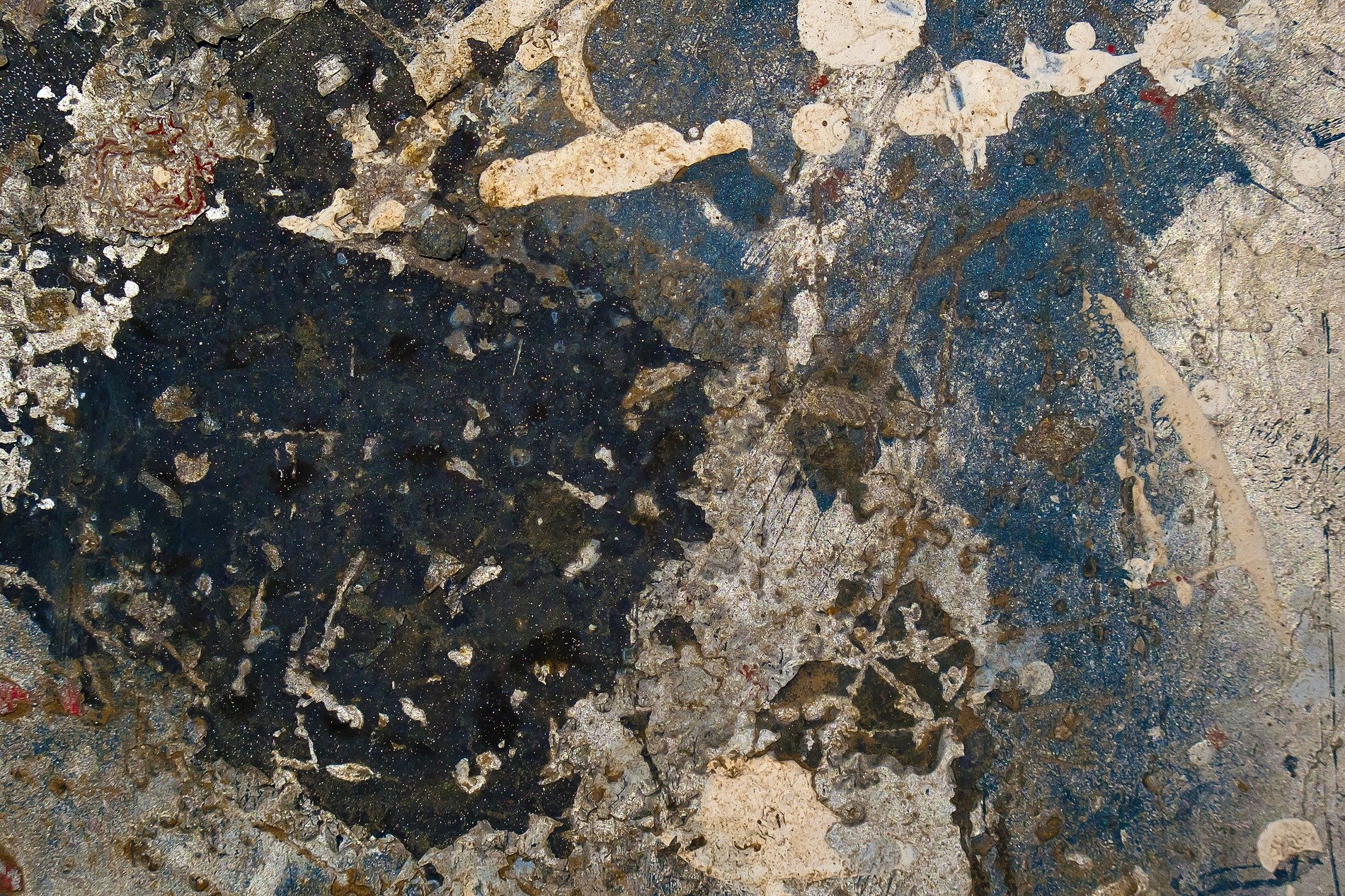 Deep red skin turns to rust, dark islands on the heavy steel, decay takes the light