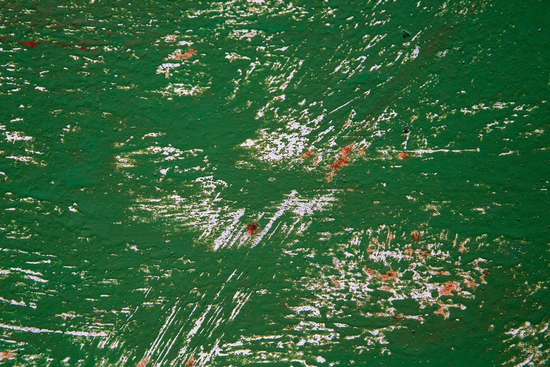 Green skin bears the scars, white and rust layers emerge, grit marks the finish