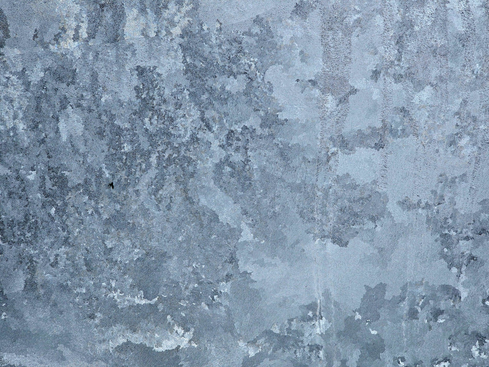 Grey fields meet the light, mottled patterns trace the skin, grit marks the finish