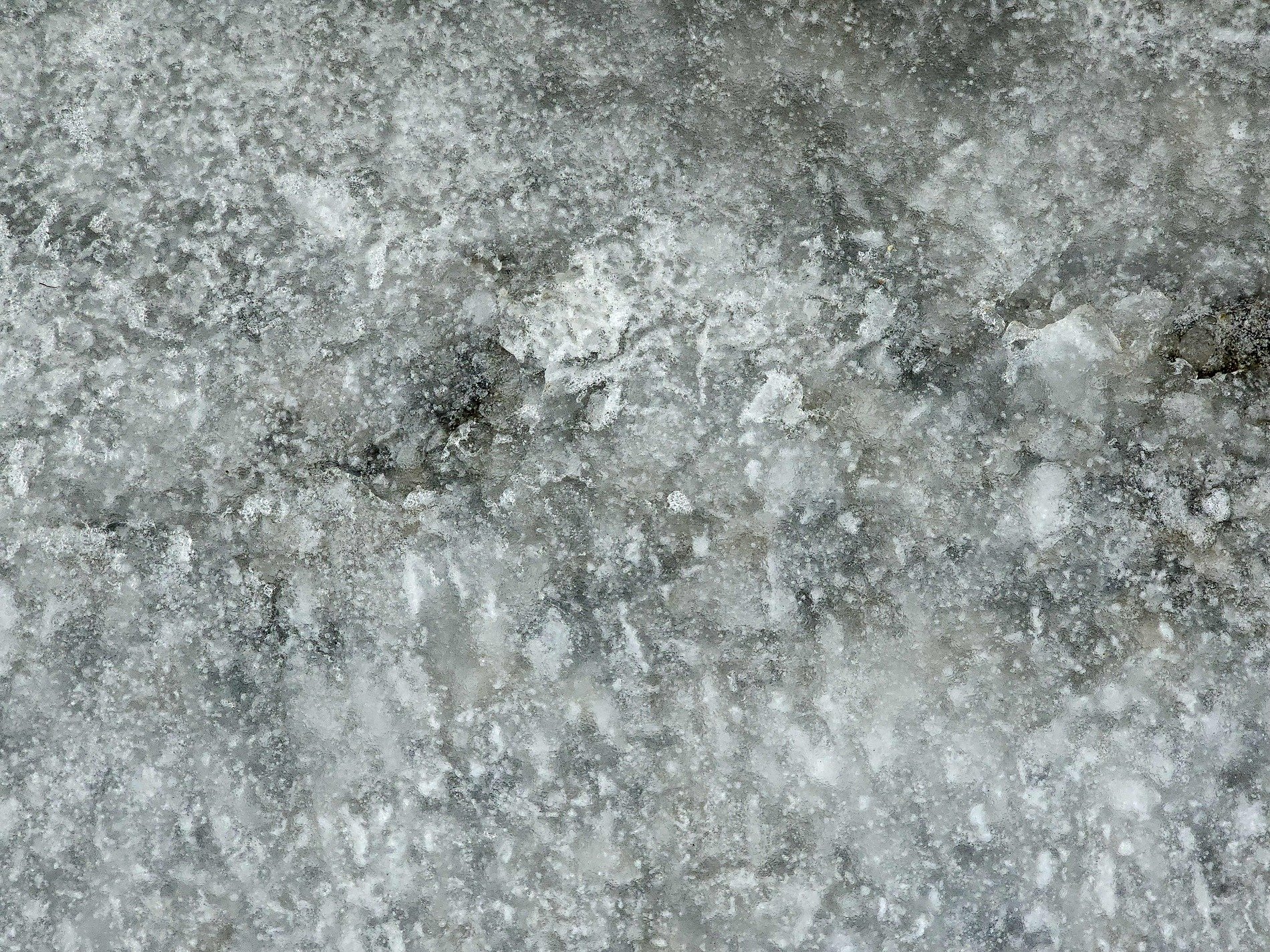 Grey slush fills the ground, frozen grit binds to the ice, winter melts away