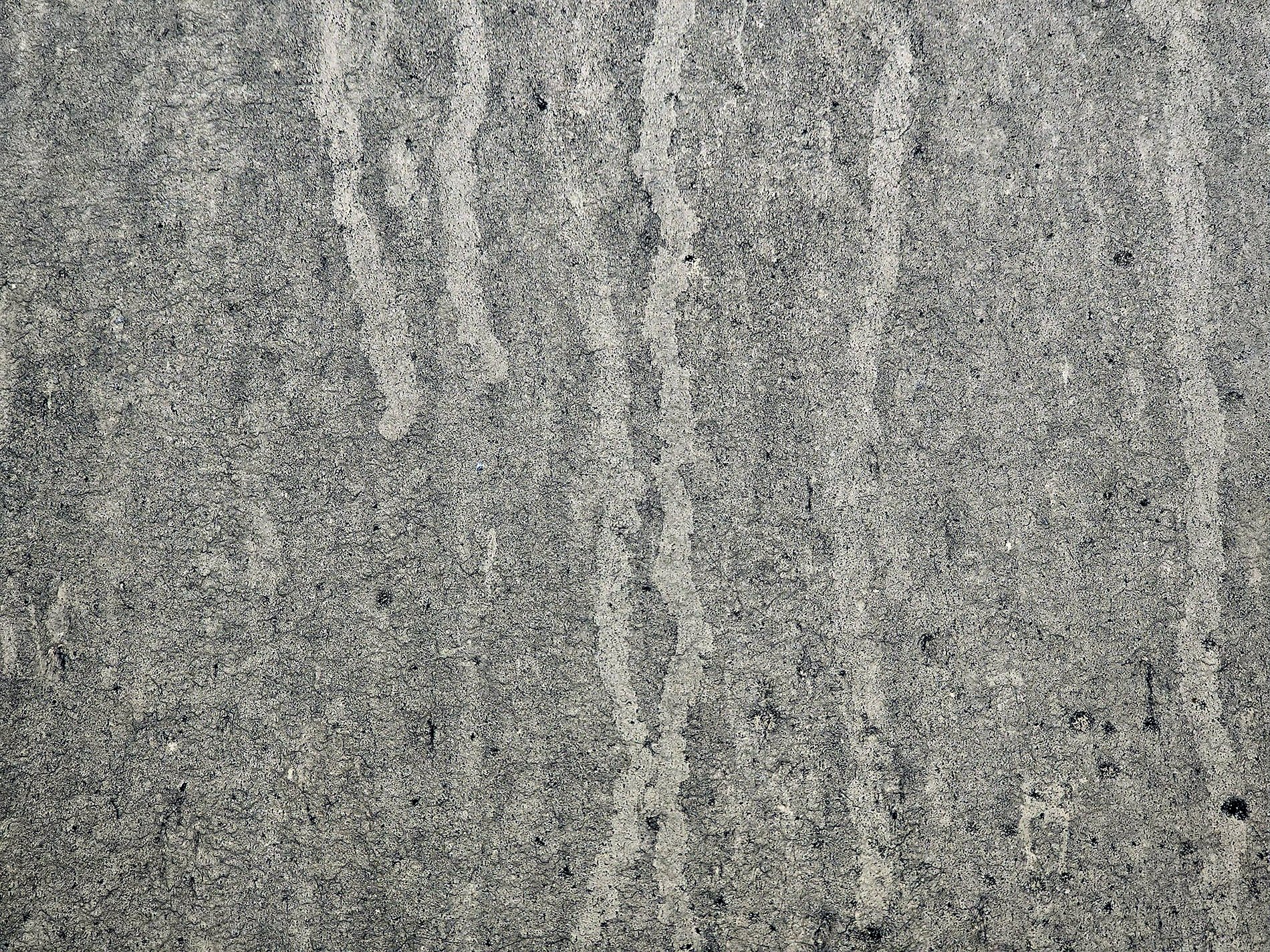 Grey streaks on the door, silver skin meets water trails, road grime leaves its mark.