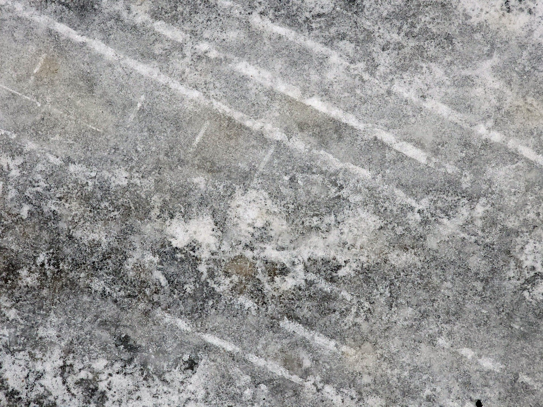 Grey streaks on the floor, white lines trace the fading path, grit meets the worn edge