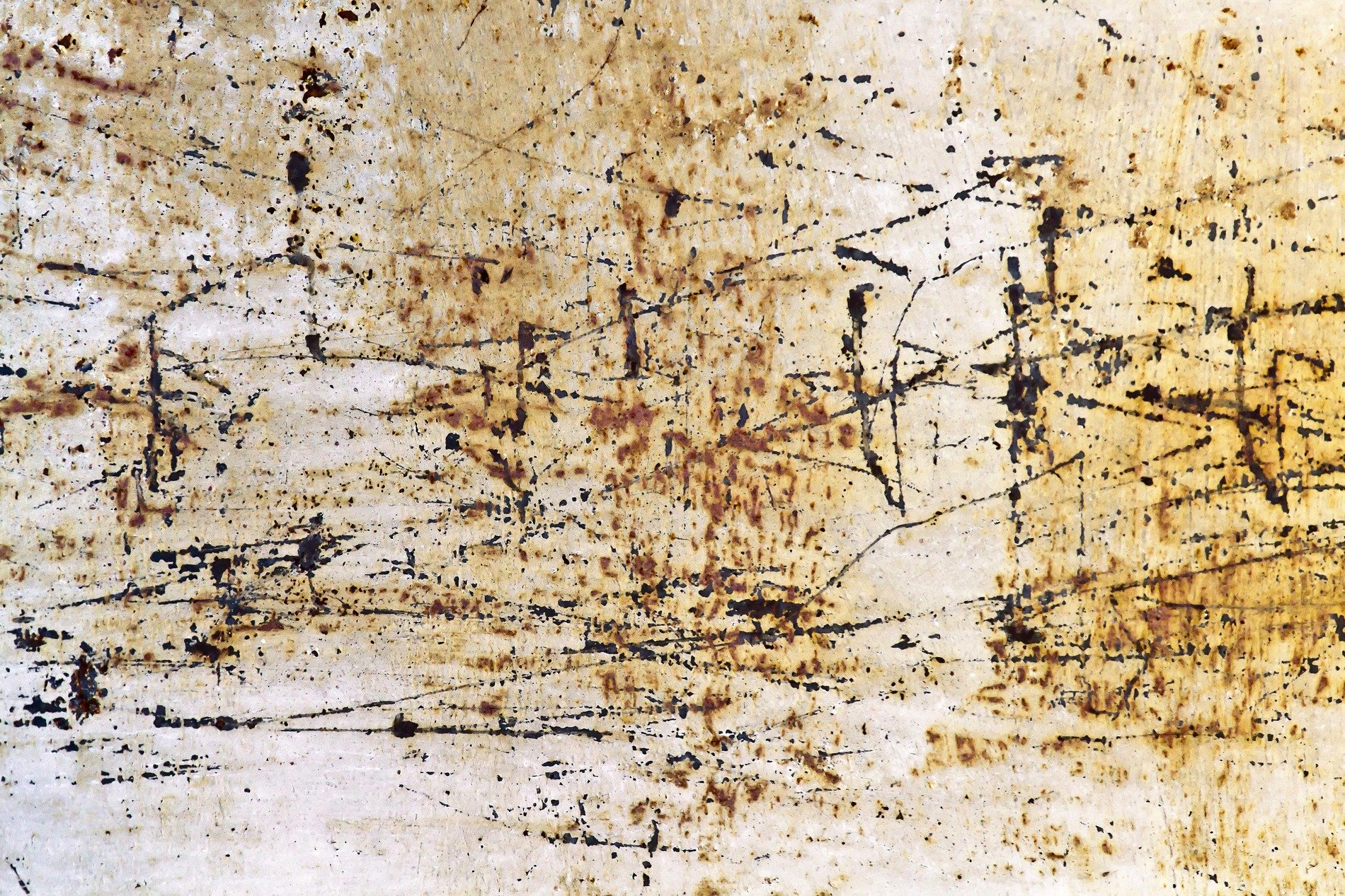 Heavy rust scales on car steel, orange and brown minerals claim the body, grit holds the decay