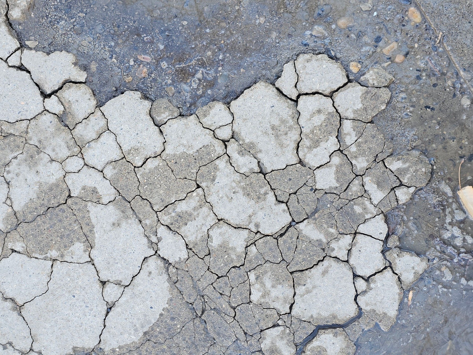 Jagged lines divide the grey, sharp edges meet the wet, grit marks the fracture