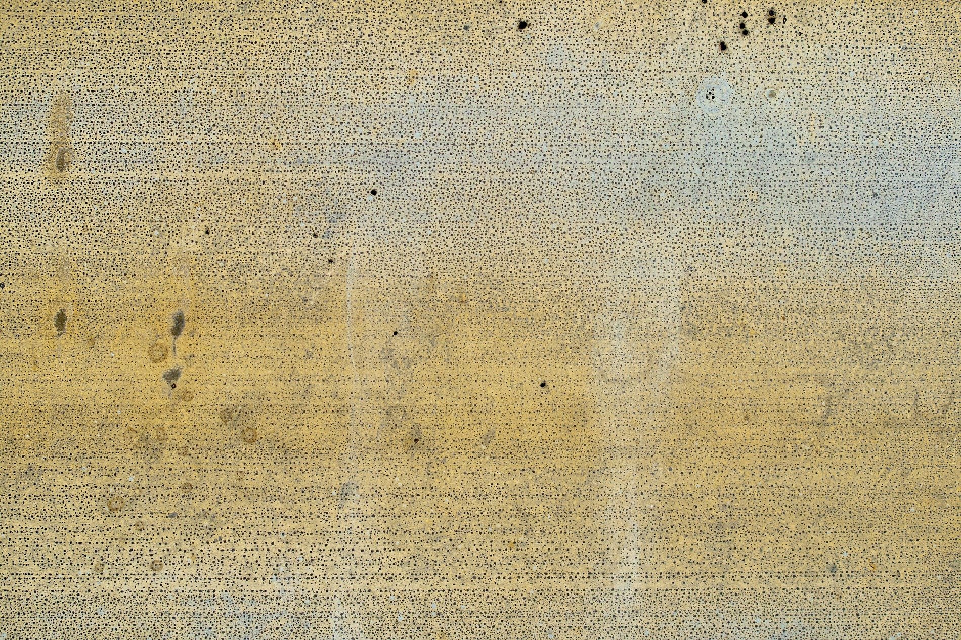 Yellowed paint decays, tiny black pits dot the plane, metal starts to show