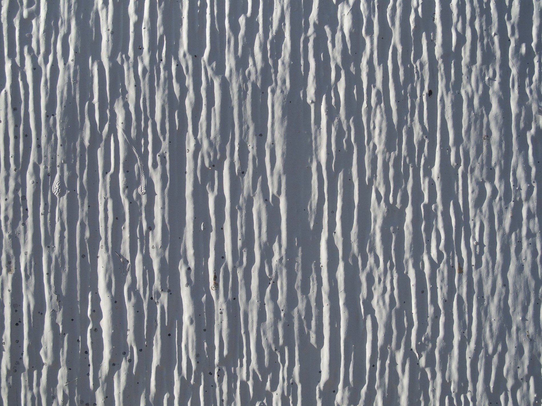 White drips frozen still, deep shadows mark vertical, rough ridges remain