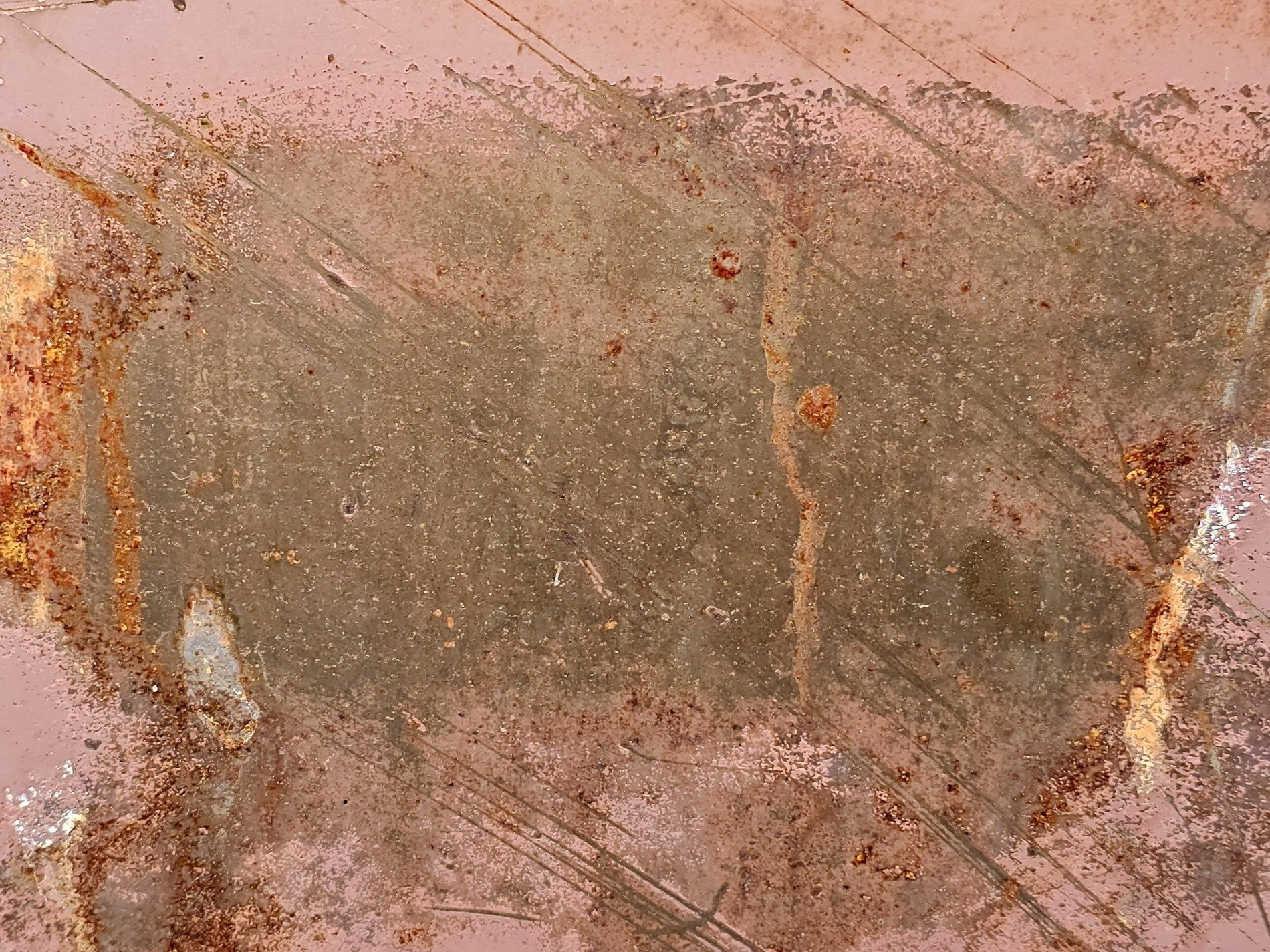 Rust blooms on the pink, scratches score the heavy steel, time's orange decay