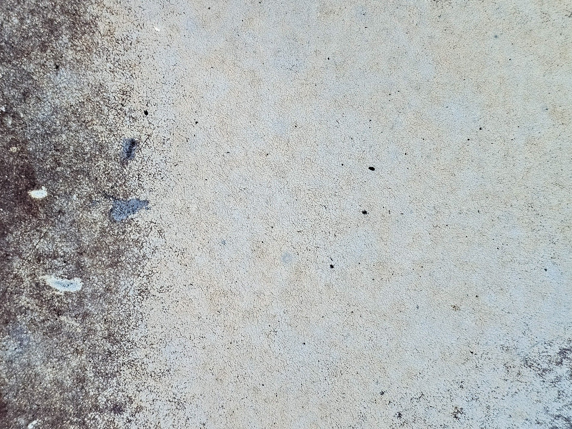 Pale skin pits and cracks, dark spots bloom on the thin wall, grit marks the finish