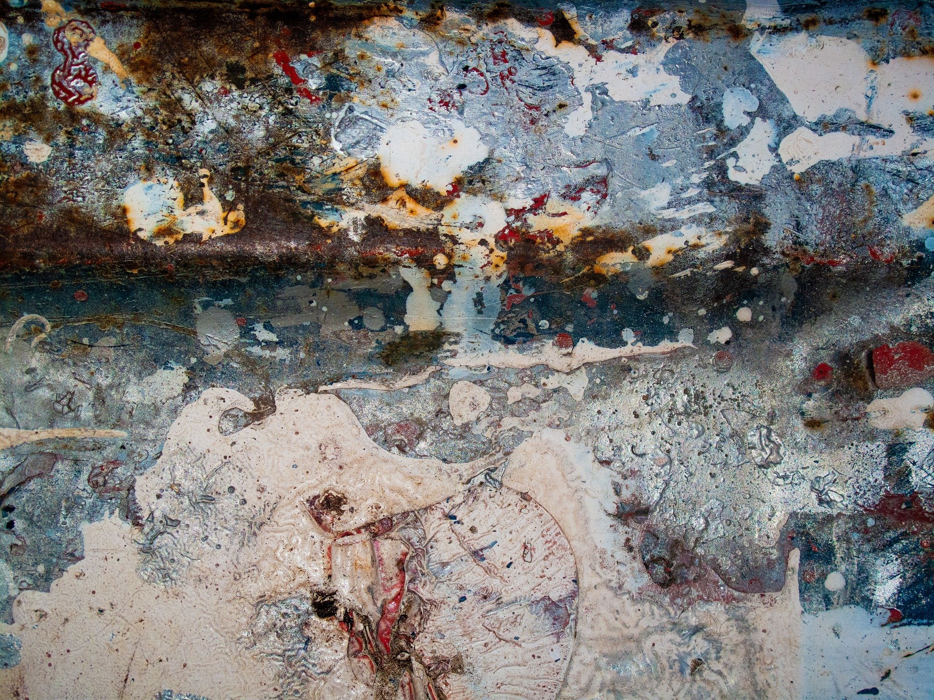 Pink floral wallpaper, faded roses on cream paper, pattern holds the age