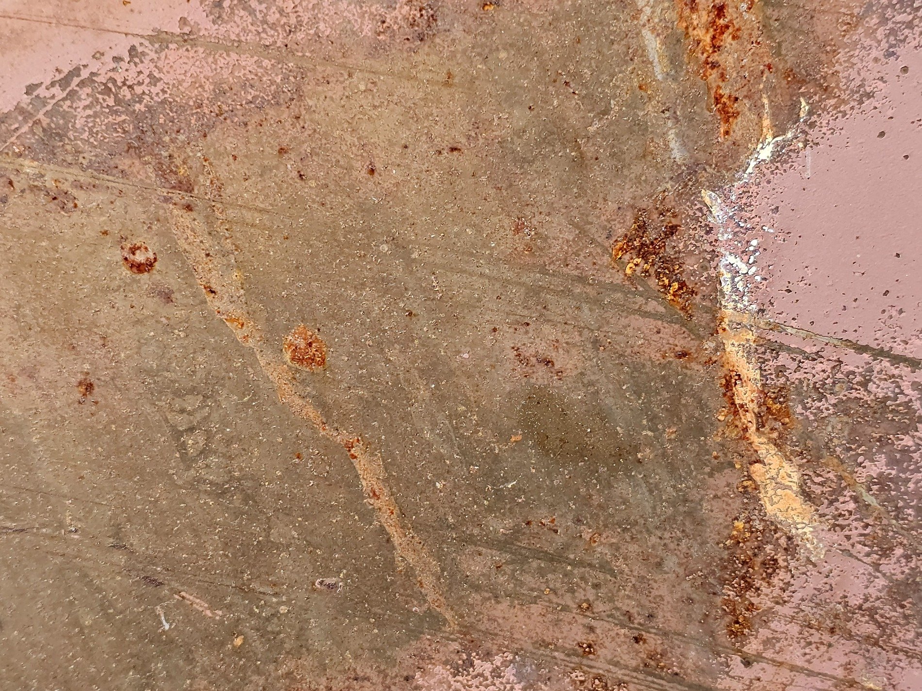 Pink paint meets the rust, orange veins bleed on the steel, time claims the finish