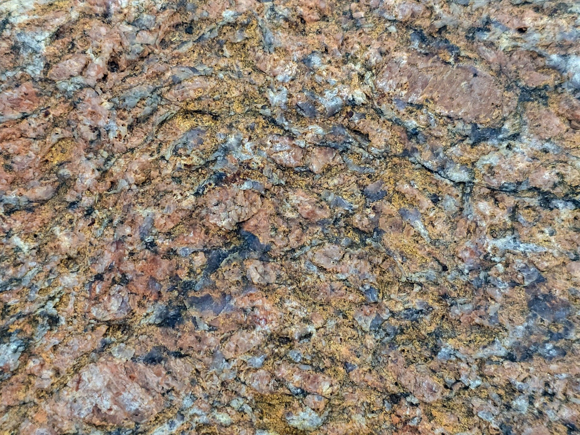 Red crystals emerge, black veins cut through orange dust, stone flows like a map