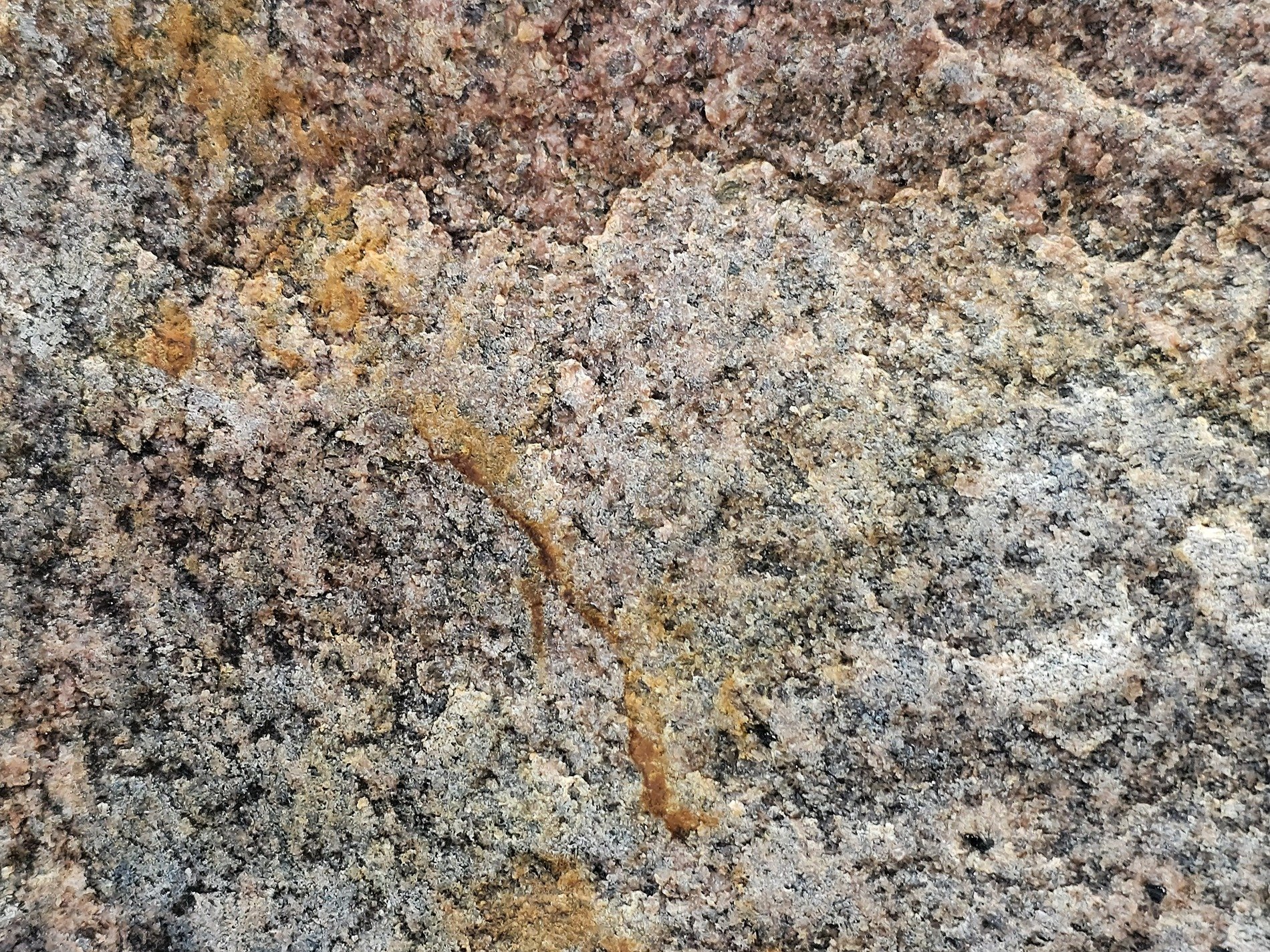 Red crystals emerge, coarse grain flows across the stone, time leaves heavy marks