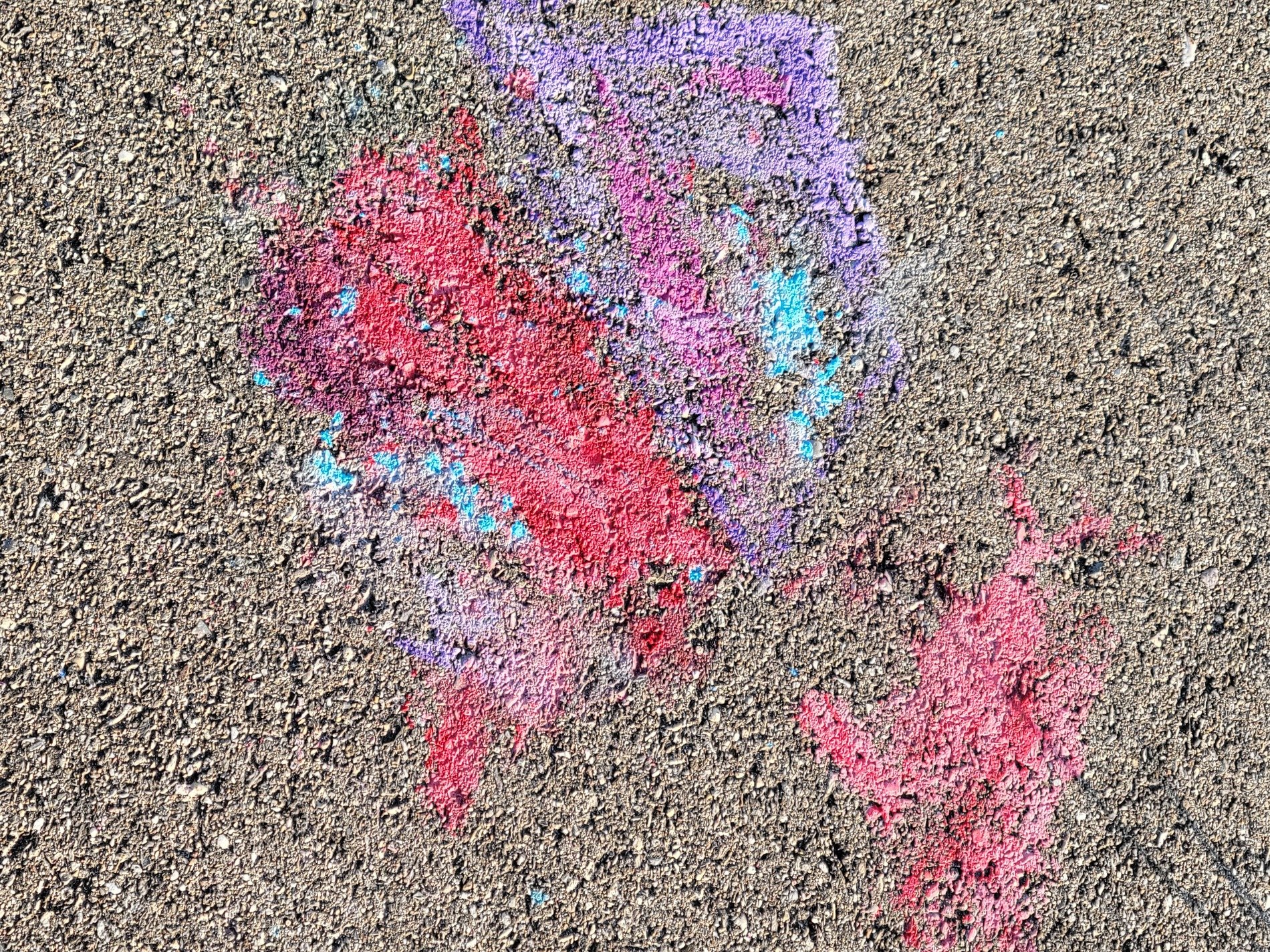 Red marks on the ground, purple dust meets the blue grit, chalk fades on the street