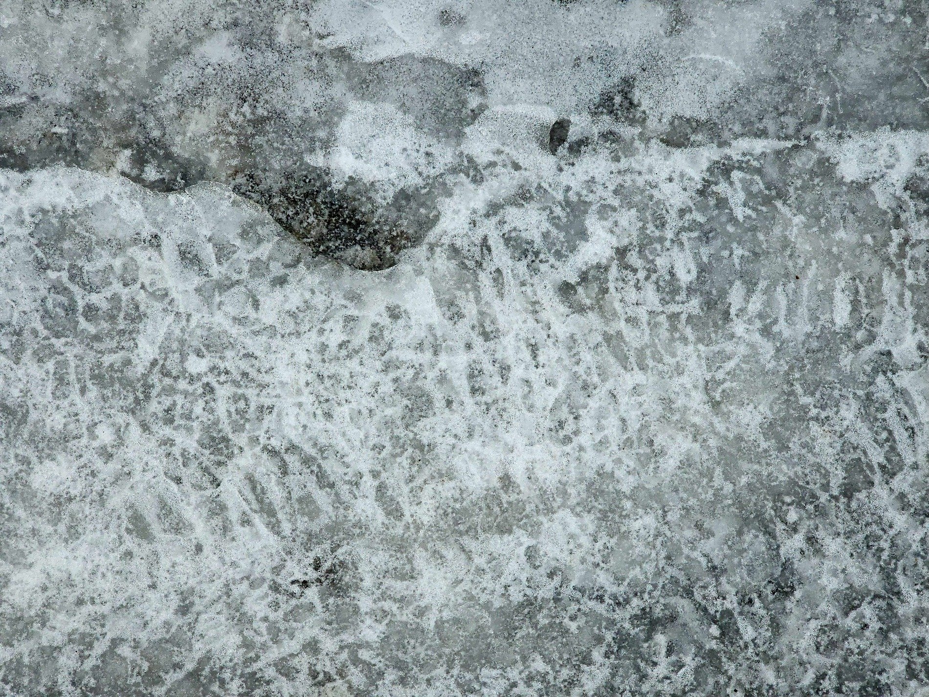 Frozen water glass, bubbles trapped in winter white, cold breath held in ice