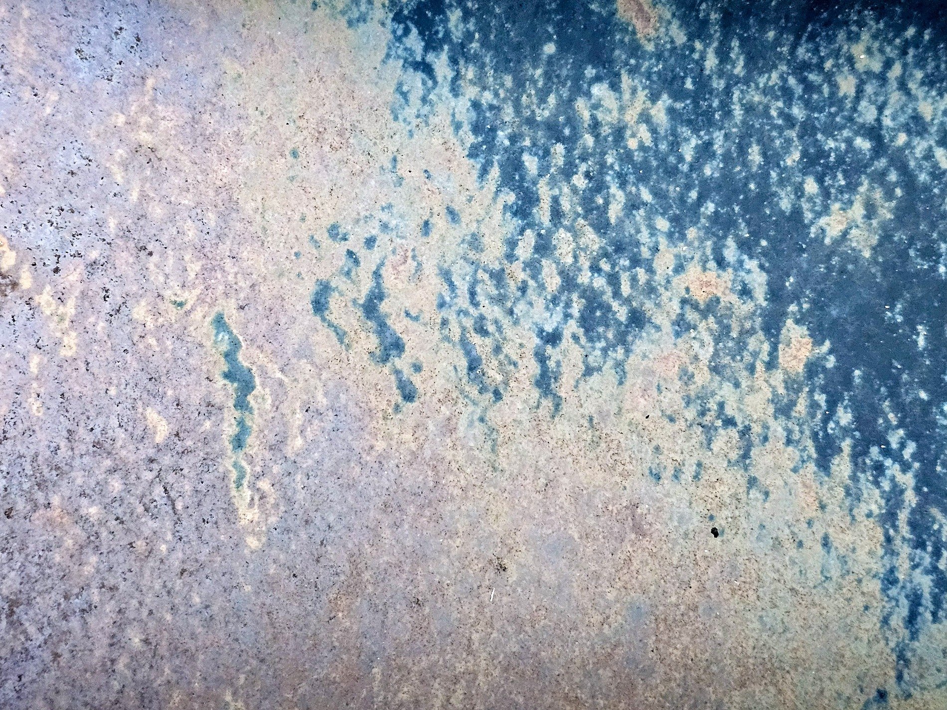Blue frost meets the rust, mottled metal skin decays, age paints on the steel