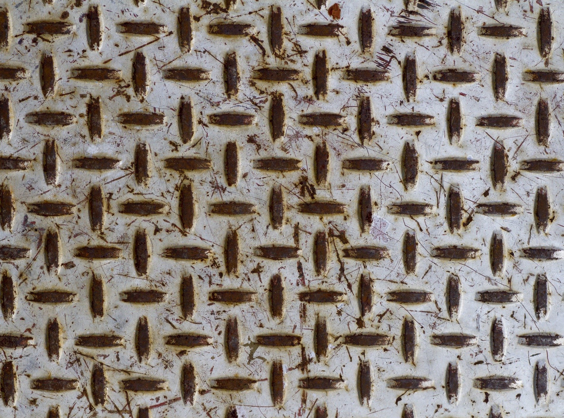 Silver skin has pits, grey circles mark the metal, light catches the grit