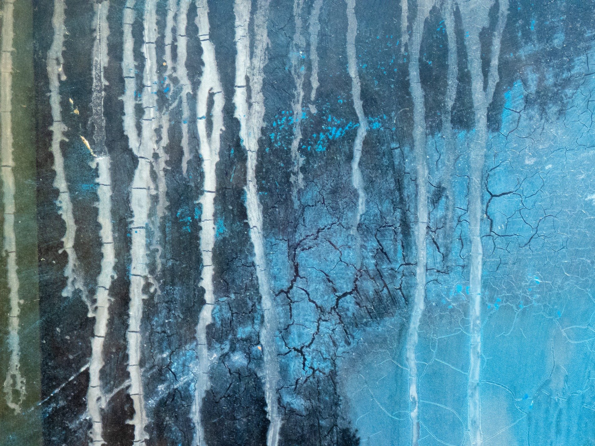 Streaks of pale descend, blue paint starts to crack and fade, shadows claim the frame