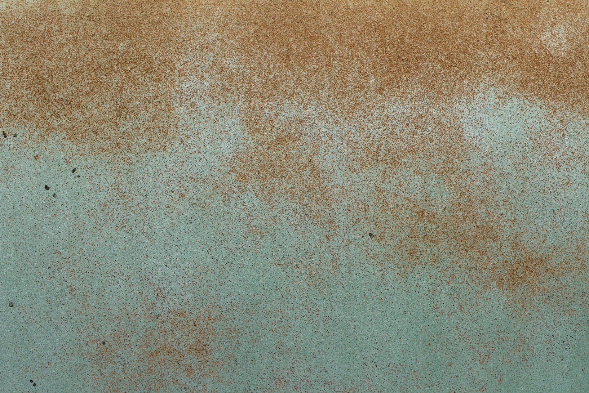 Teal paint starts to fade, orange dust across the steel, iron meets the air