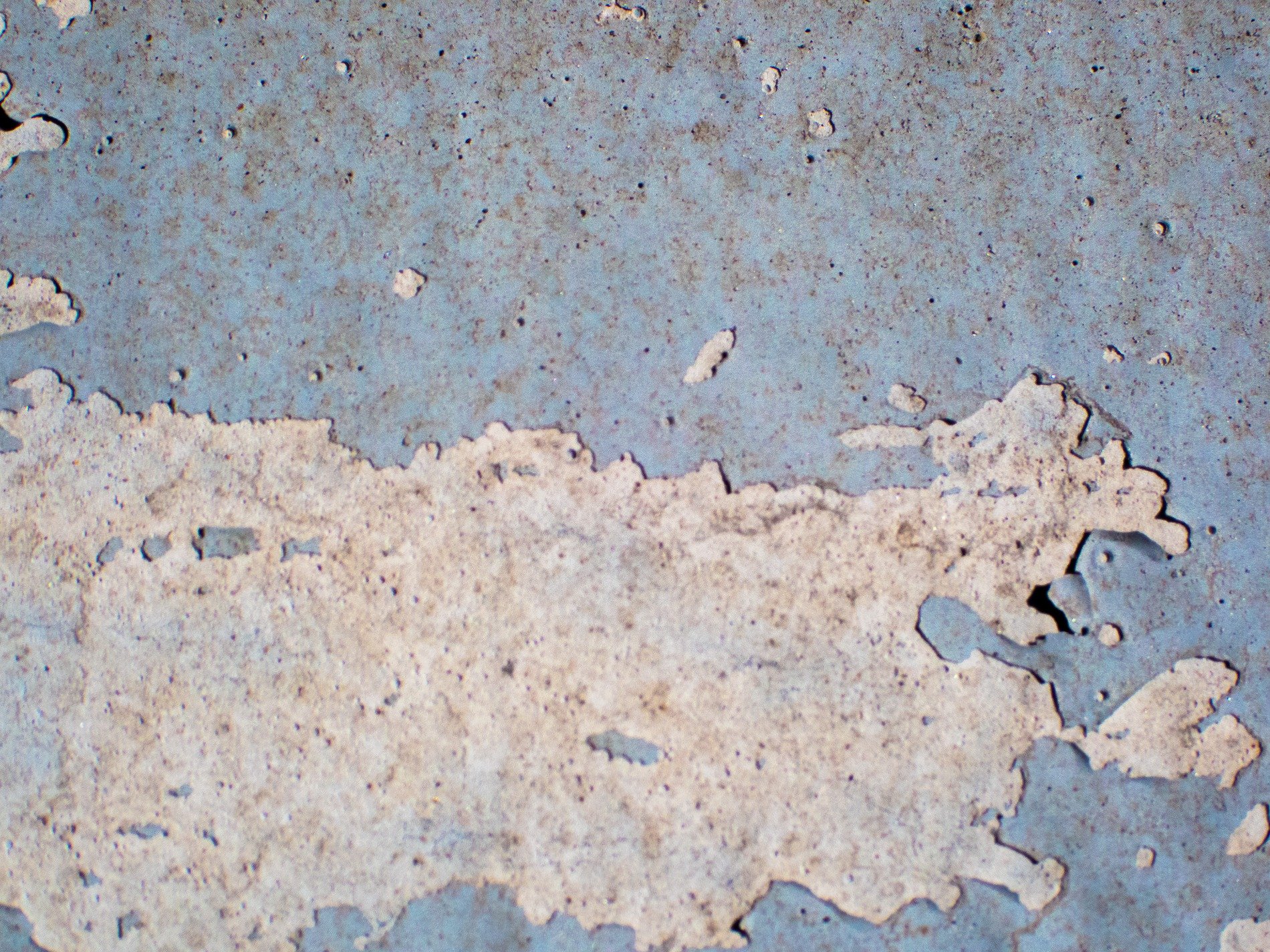 Blue surface recedes, jagged white edges emerge, gritty scars remain