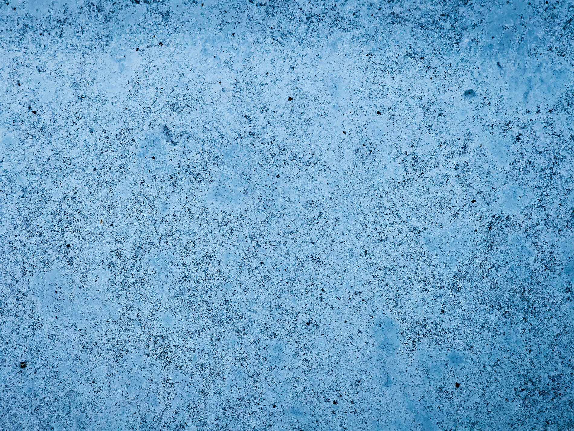 Speckled blue metallic, dark pits scar the faded coat, time wears down the gloss.