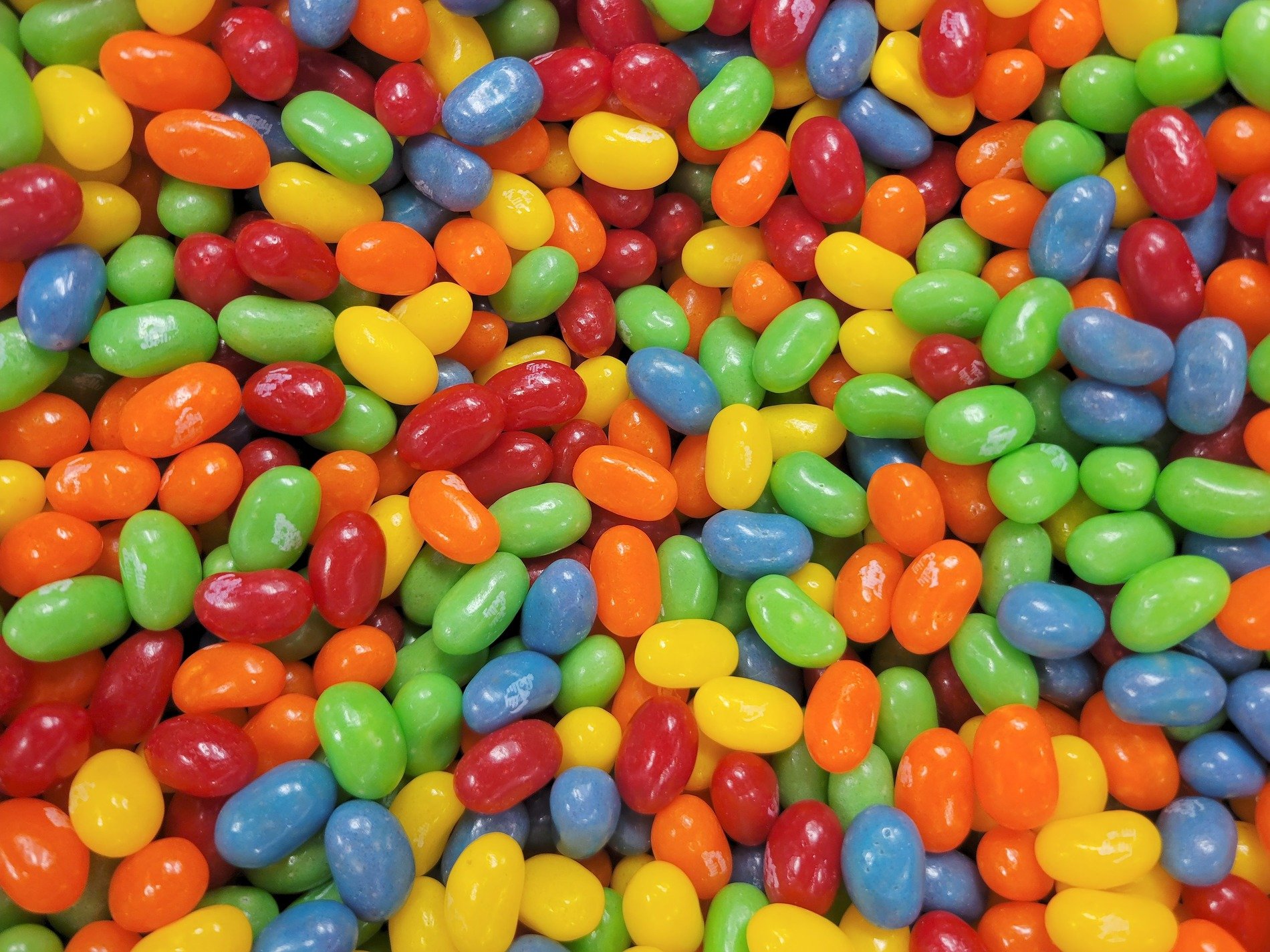 Sweet gems tumble down, rainbow shells of polished gloss, sugar takes its shape