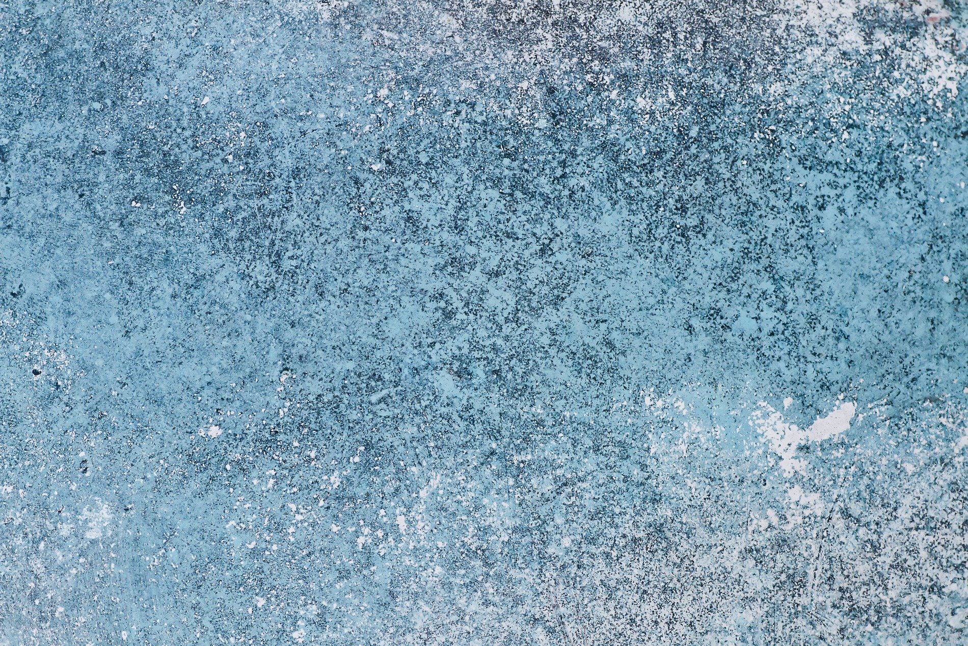 Teal paint meets the rust, orange veins bleed on the car, grit marks the finish