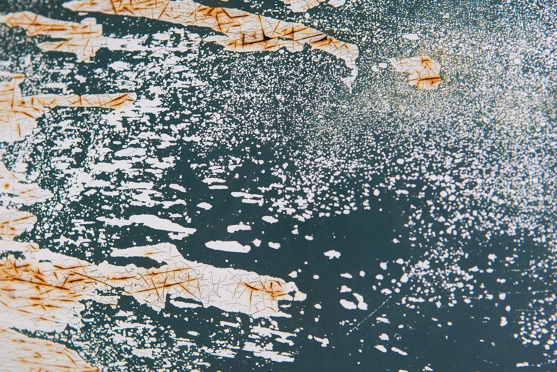 Teal skin meets the oxidation, orange rust veins bleed, grit holds the finish