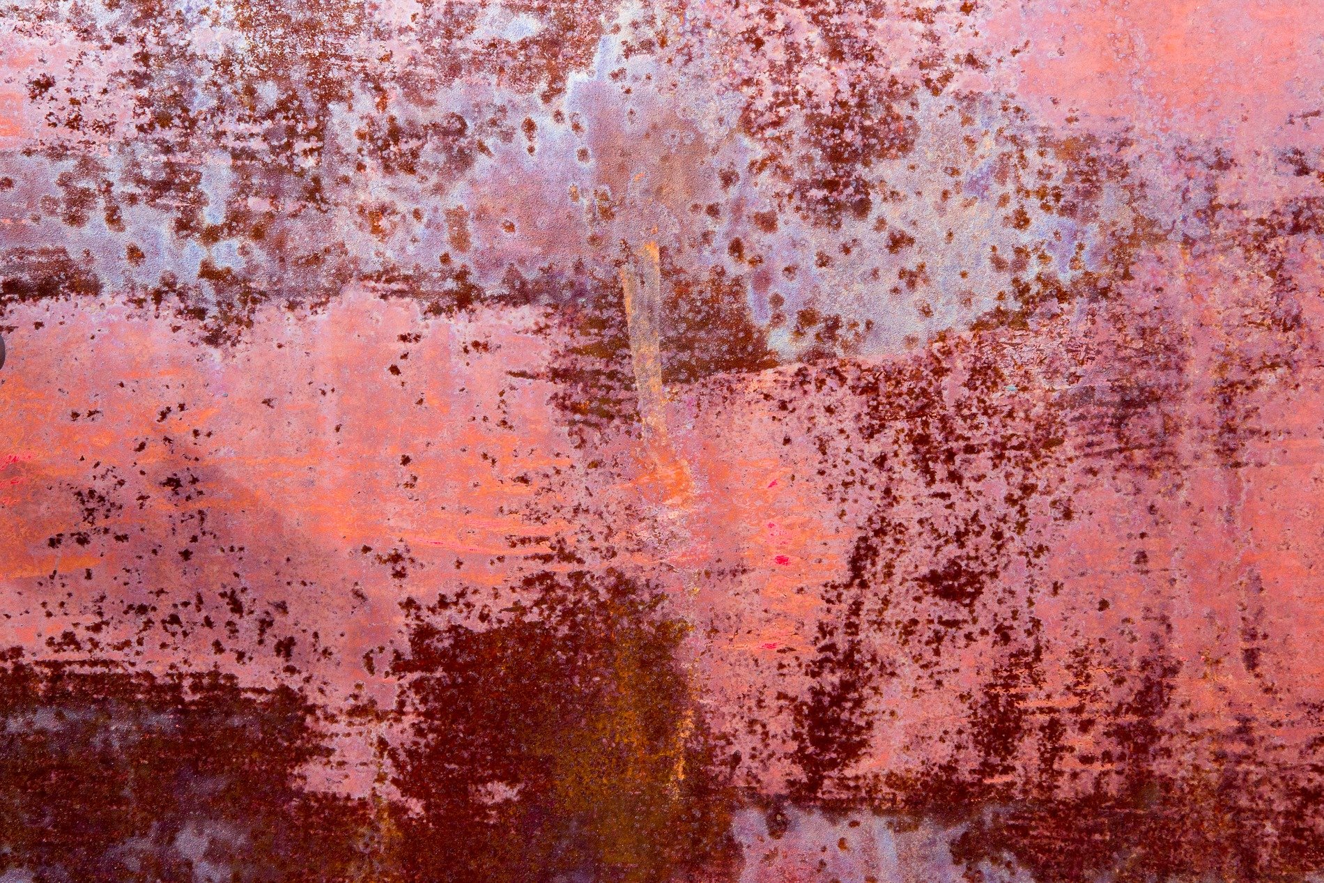 Teal skin turns to rust, dark islands on the steel, decay takes the light